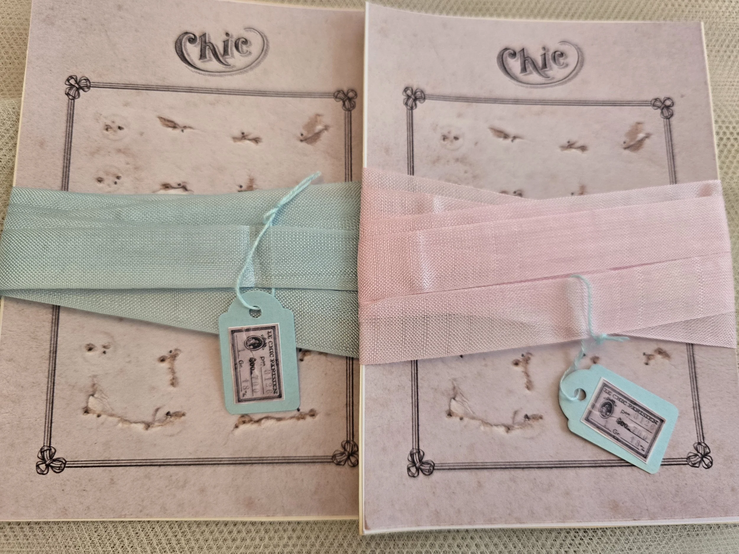 Vintage French ribbon presented on decorative studio-made Chic haberdashery cards in powder pink and pale blue.