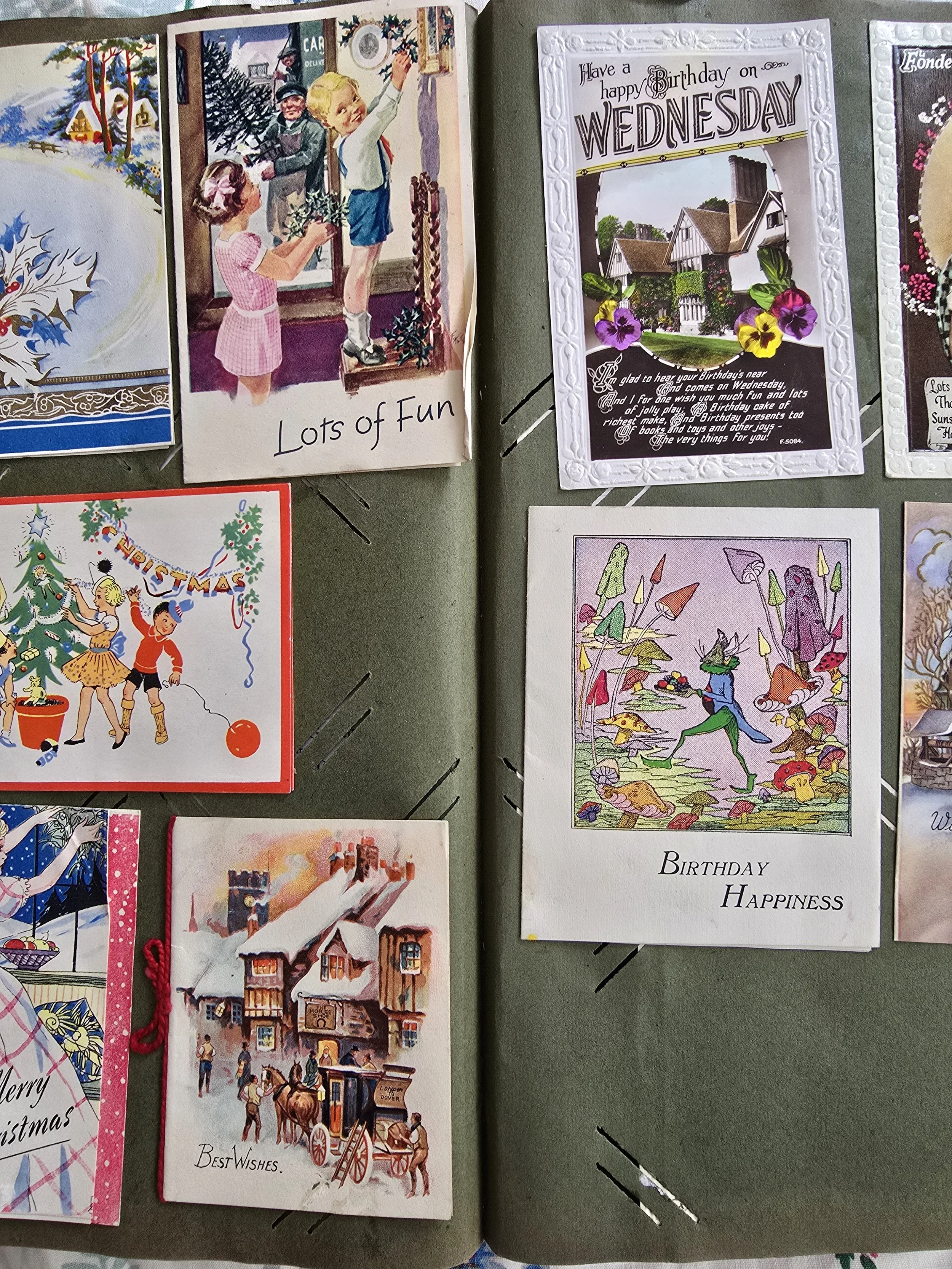 Vintage greeting cards including birthday and Christmas illustrations on scrapbook page