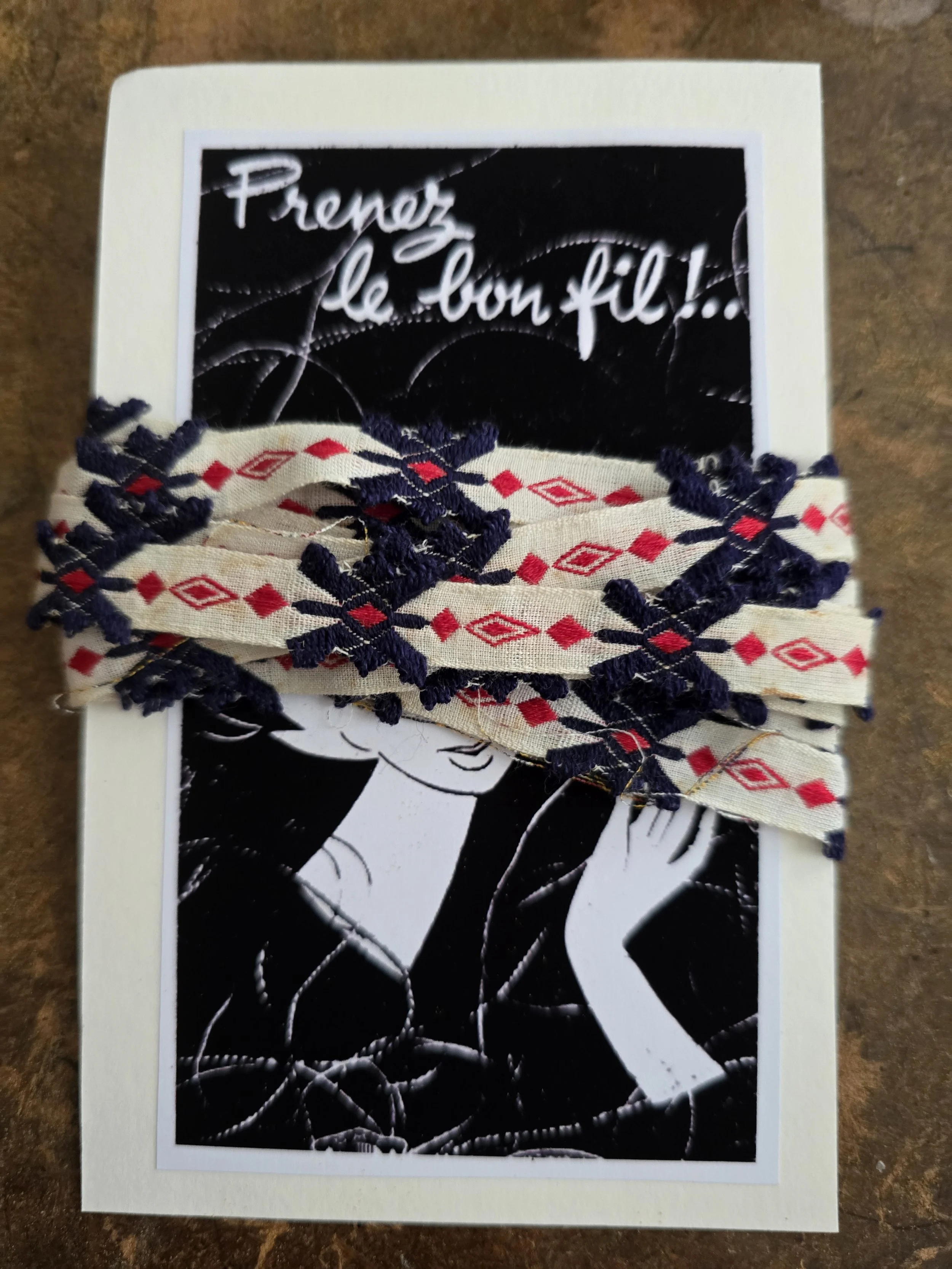 Vintage French woven trim in navy blue, red and cream, presented on a handmade card using an old French image.