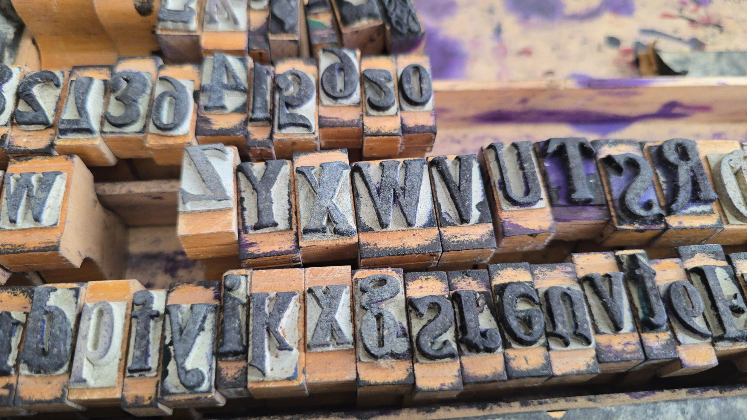Antique rubber stamps featuring pointing hand and decorative characters.