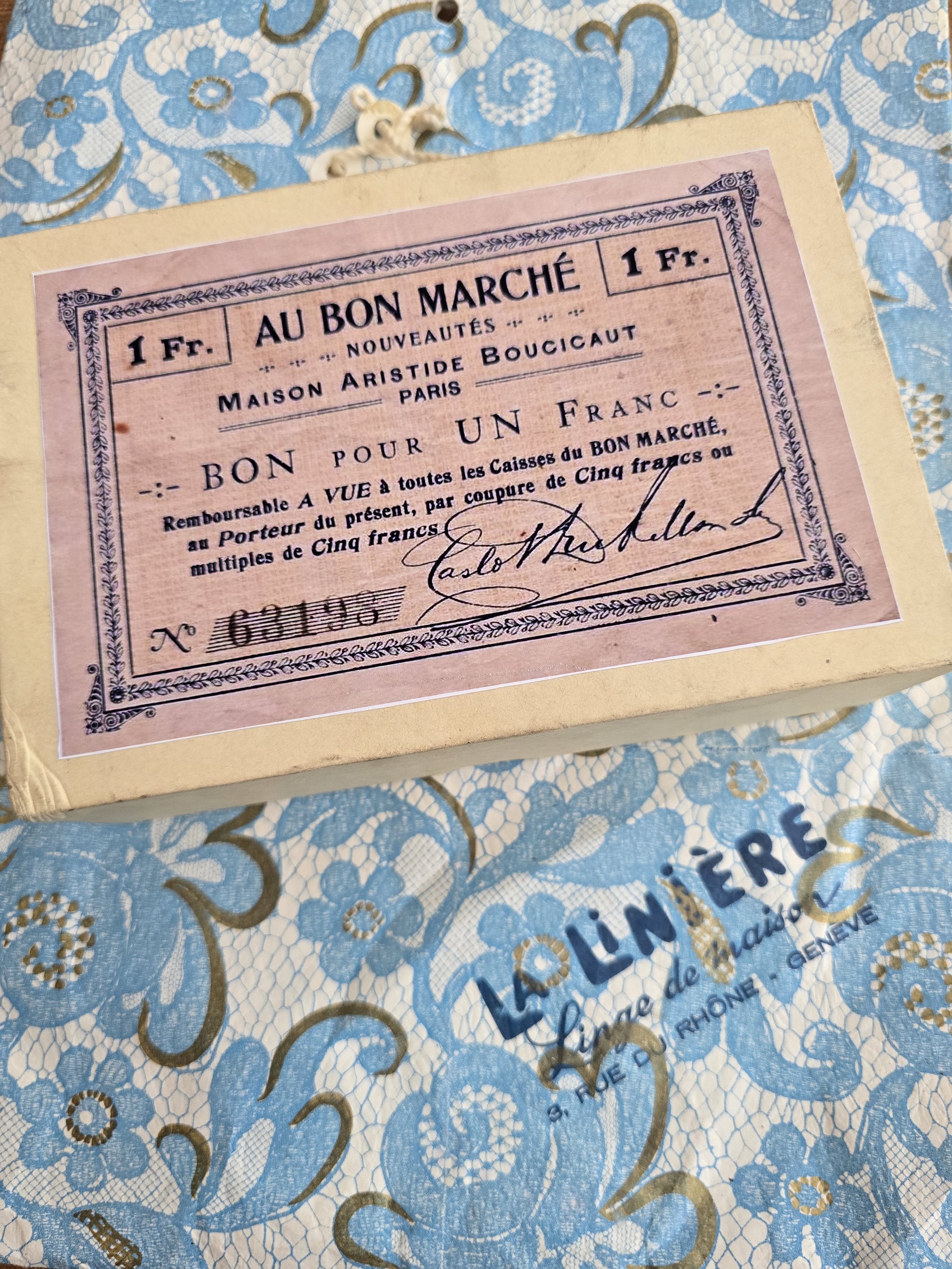 Vintage book box with reproduction Au Bon Marché Paris voucher label on the cover.