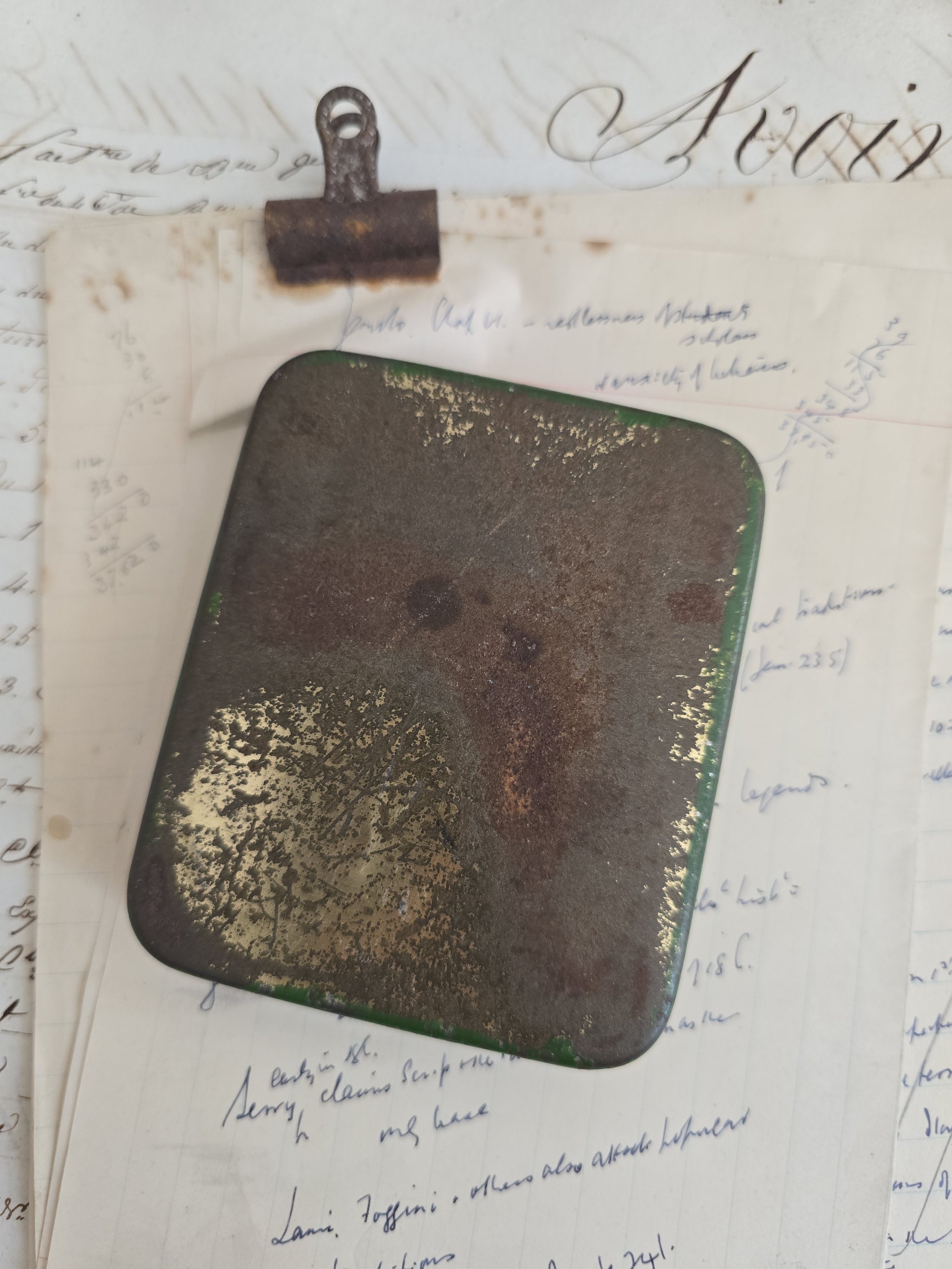 Reclaimed antique tin showing aged patina and original green paint to reverse.