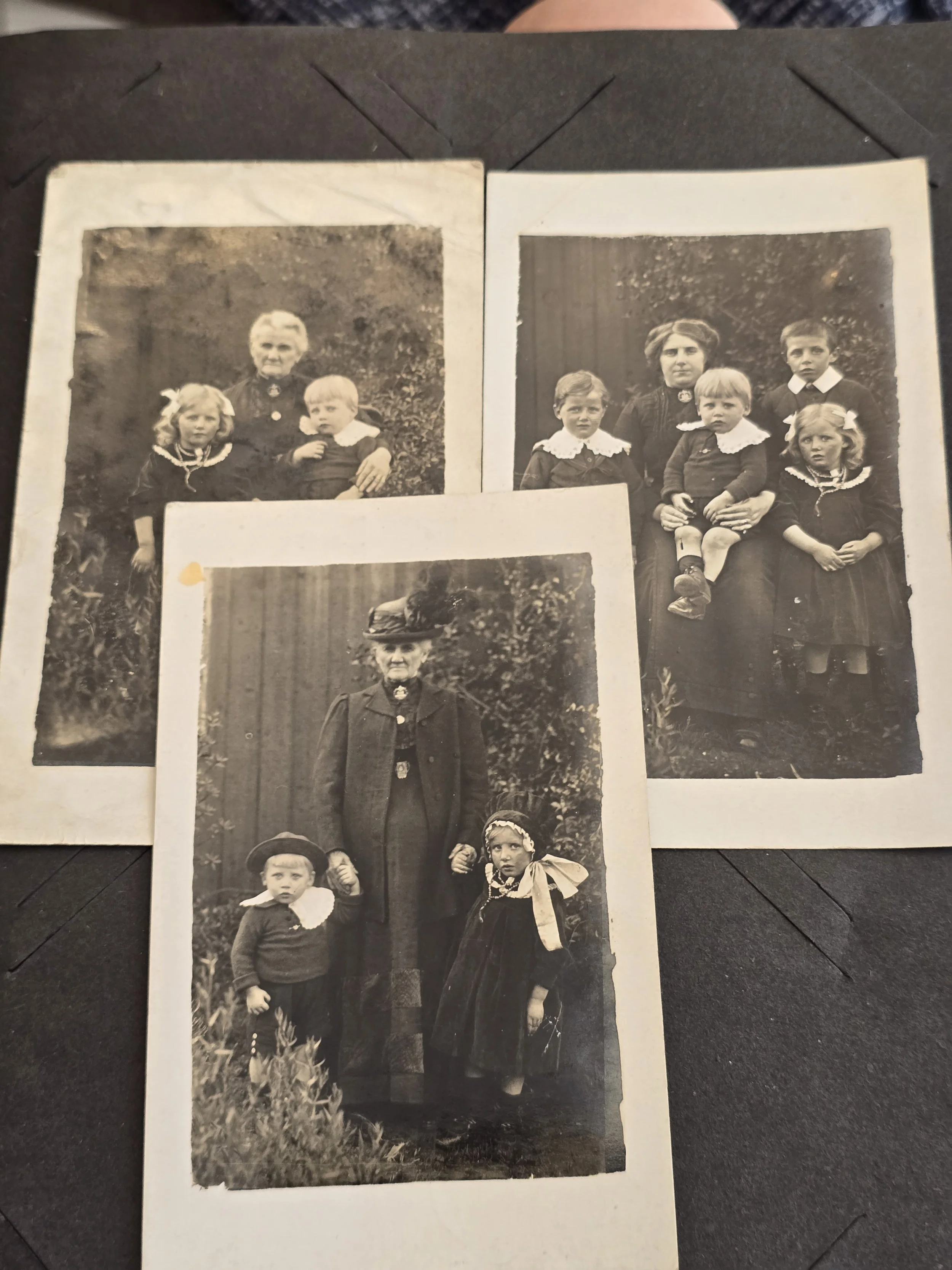 Set of three original c.1910s family photographic postcards showing women and children in a garden.