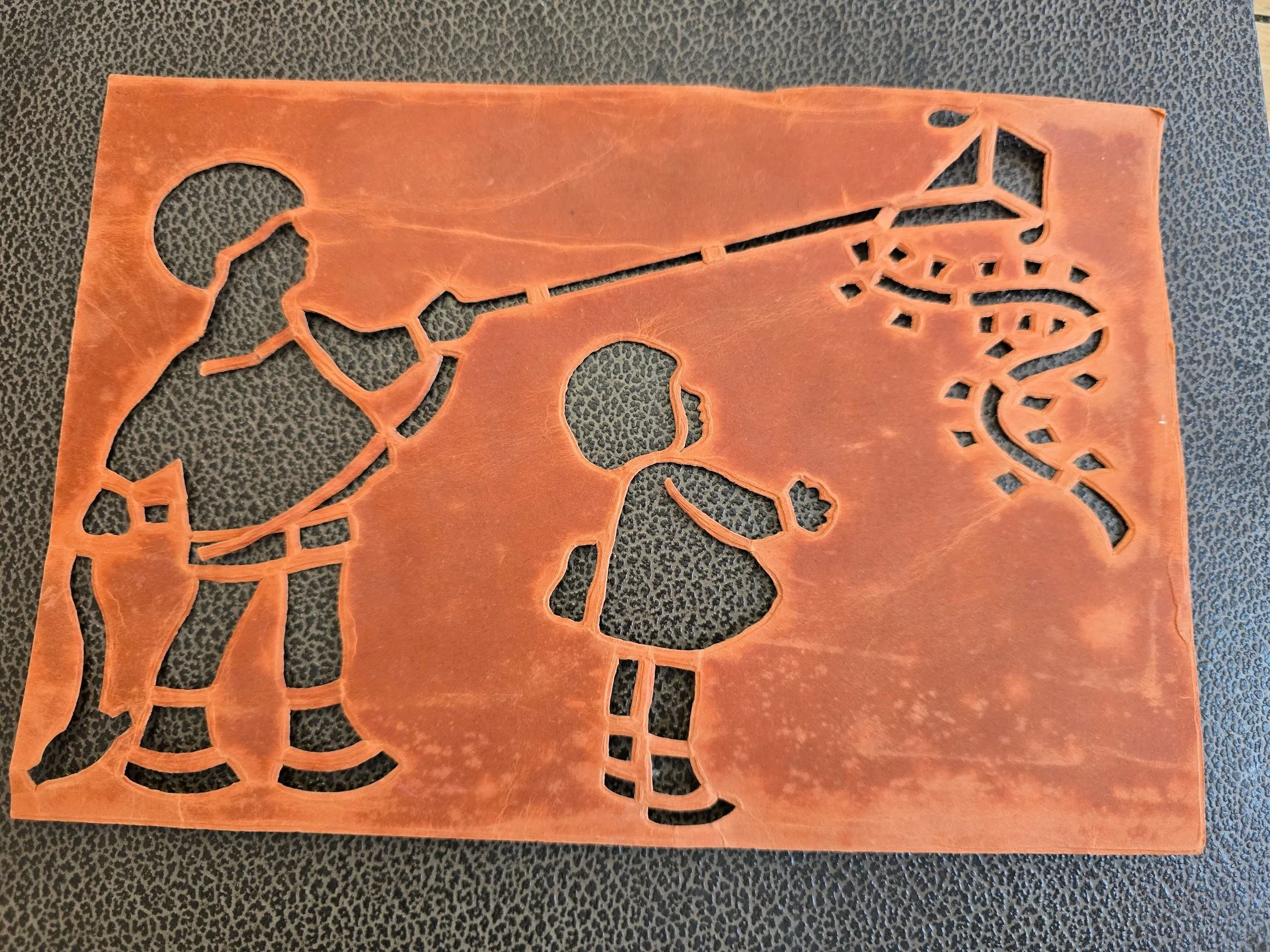 Vintage red card stencil featuring playful children's silhouettes and decorative shapes, believed to date from the 1920s or 1930s