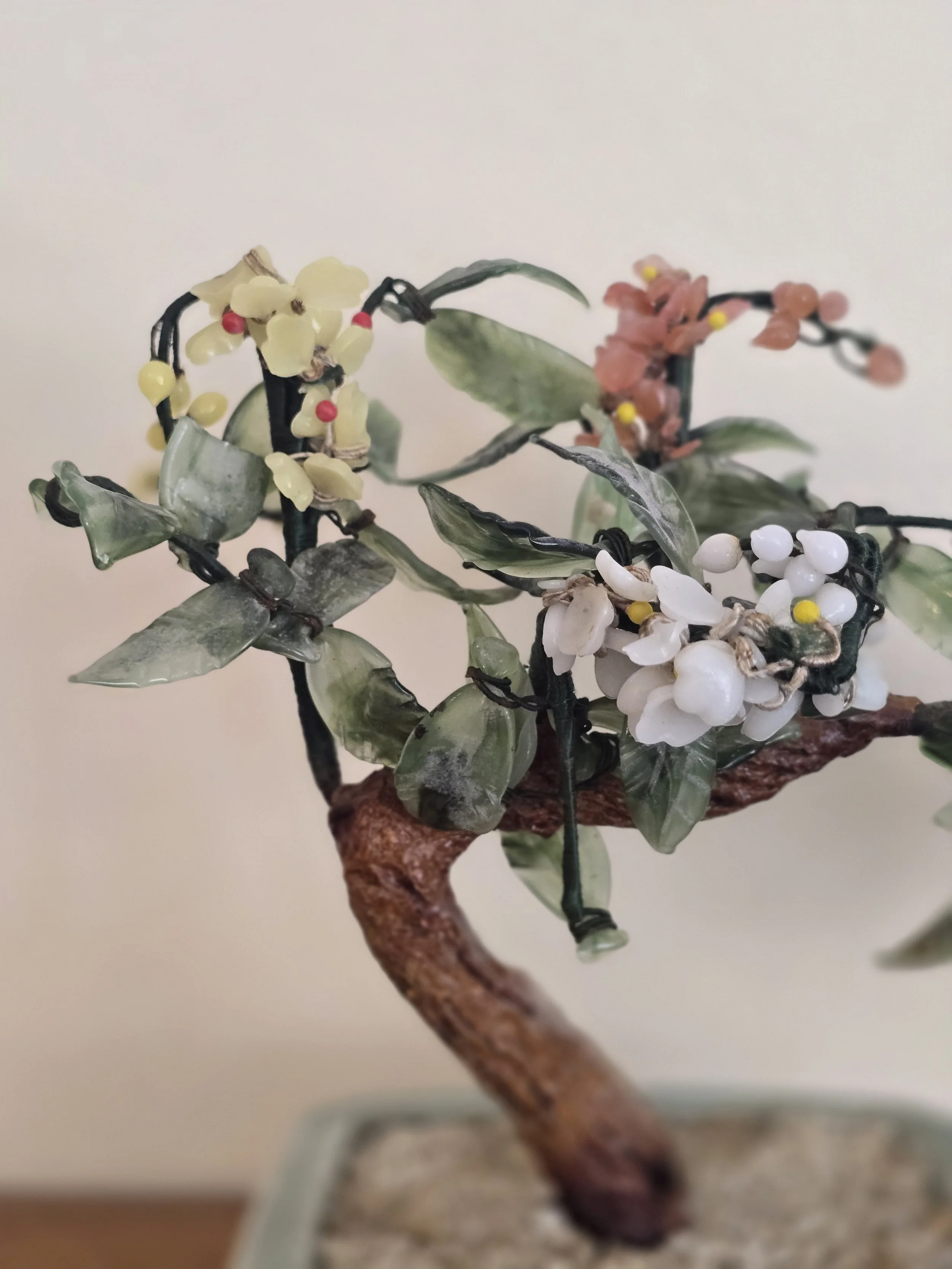 Vintage ornamental bonsai sculpture in pale green ceramic planter