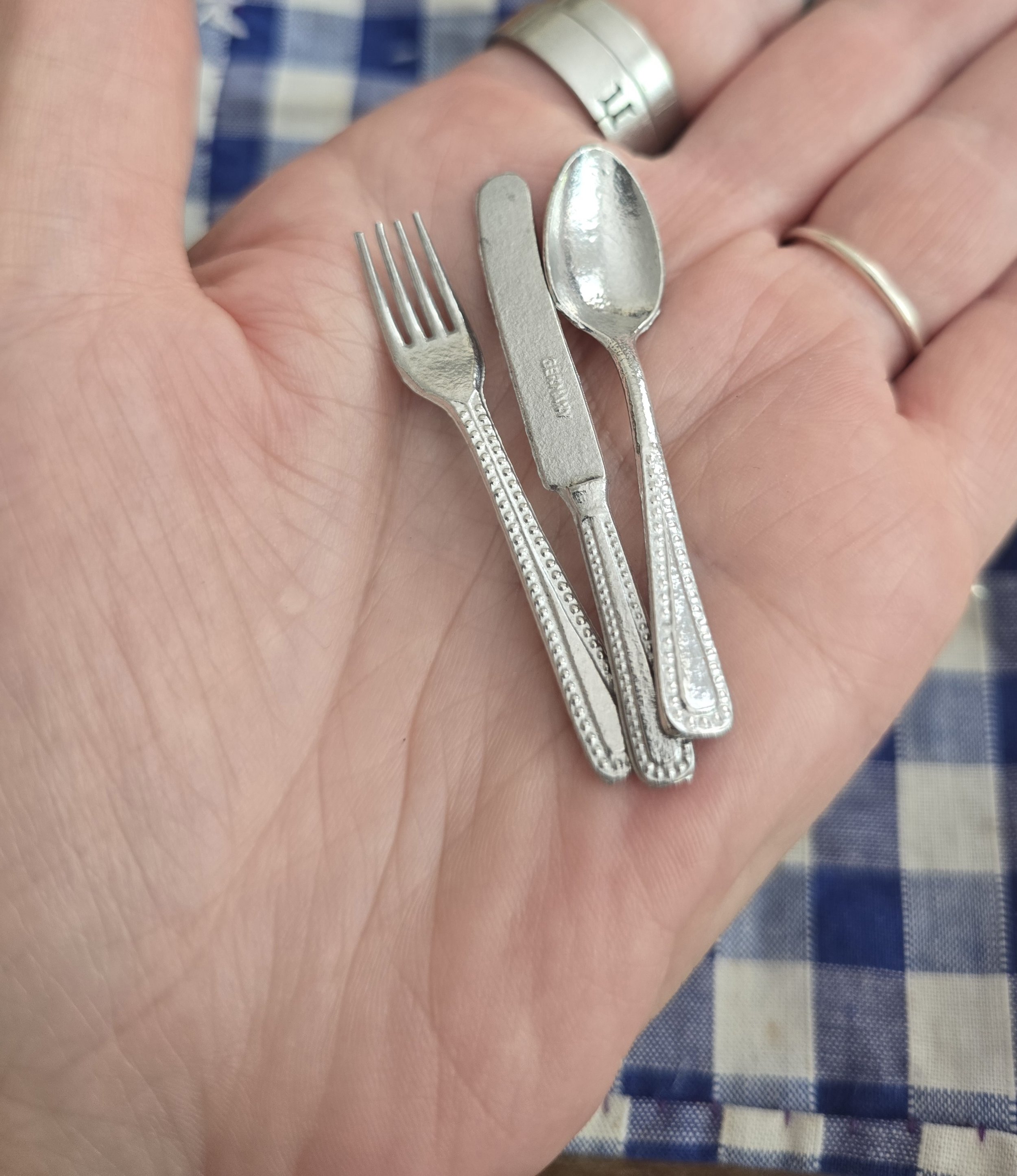 Vintage dolls house flatware displayed in compartment tray