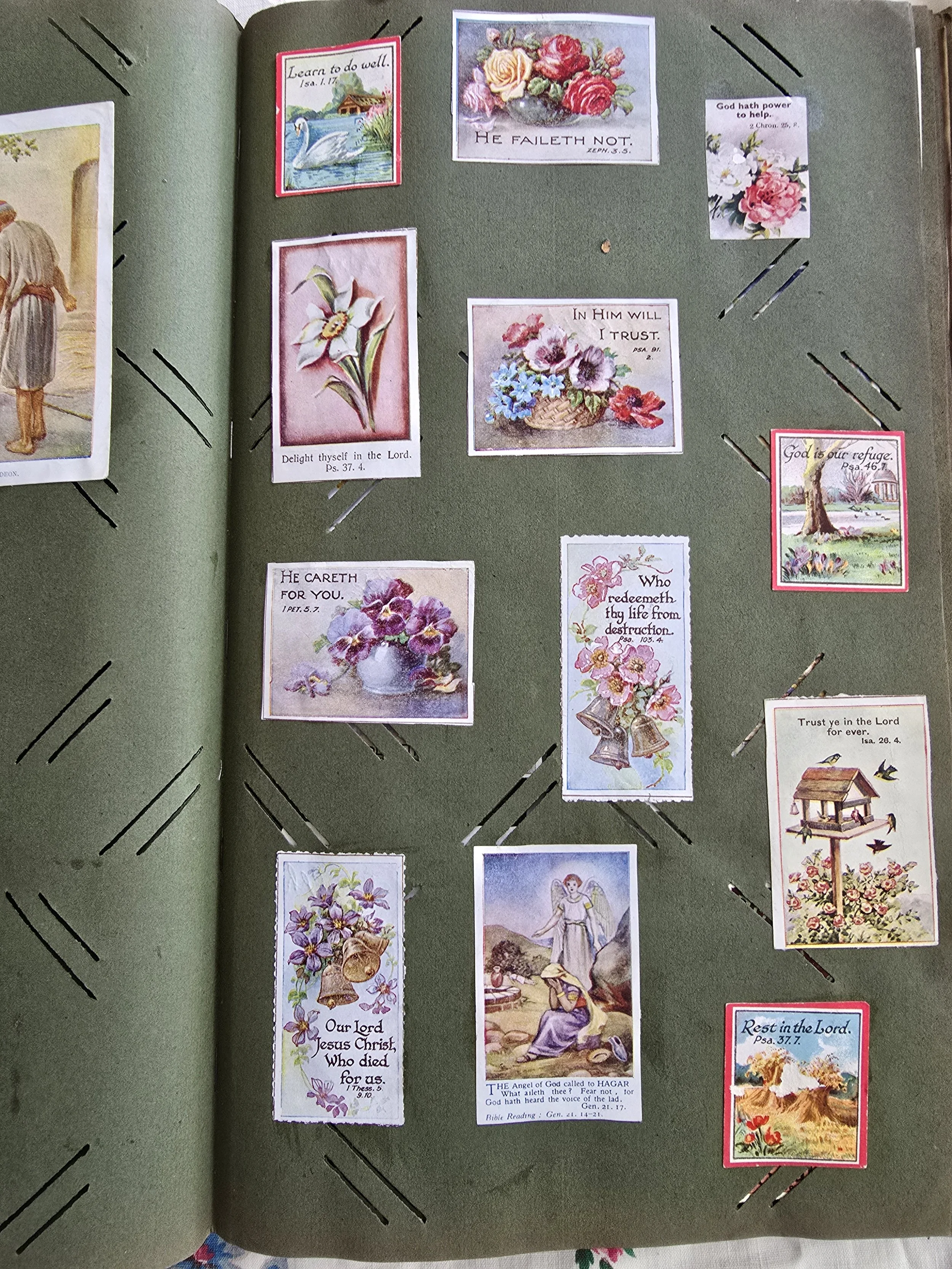 Scrapbook page with Edwardian religious motto cards decorated with flowers, Bible verses, and pastoral illustrations.