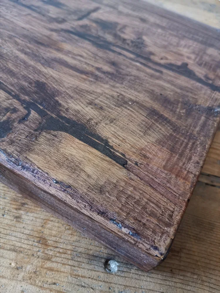 Rustic French oak cutting board aged surface with darkened character marks