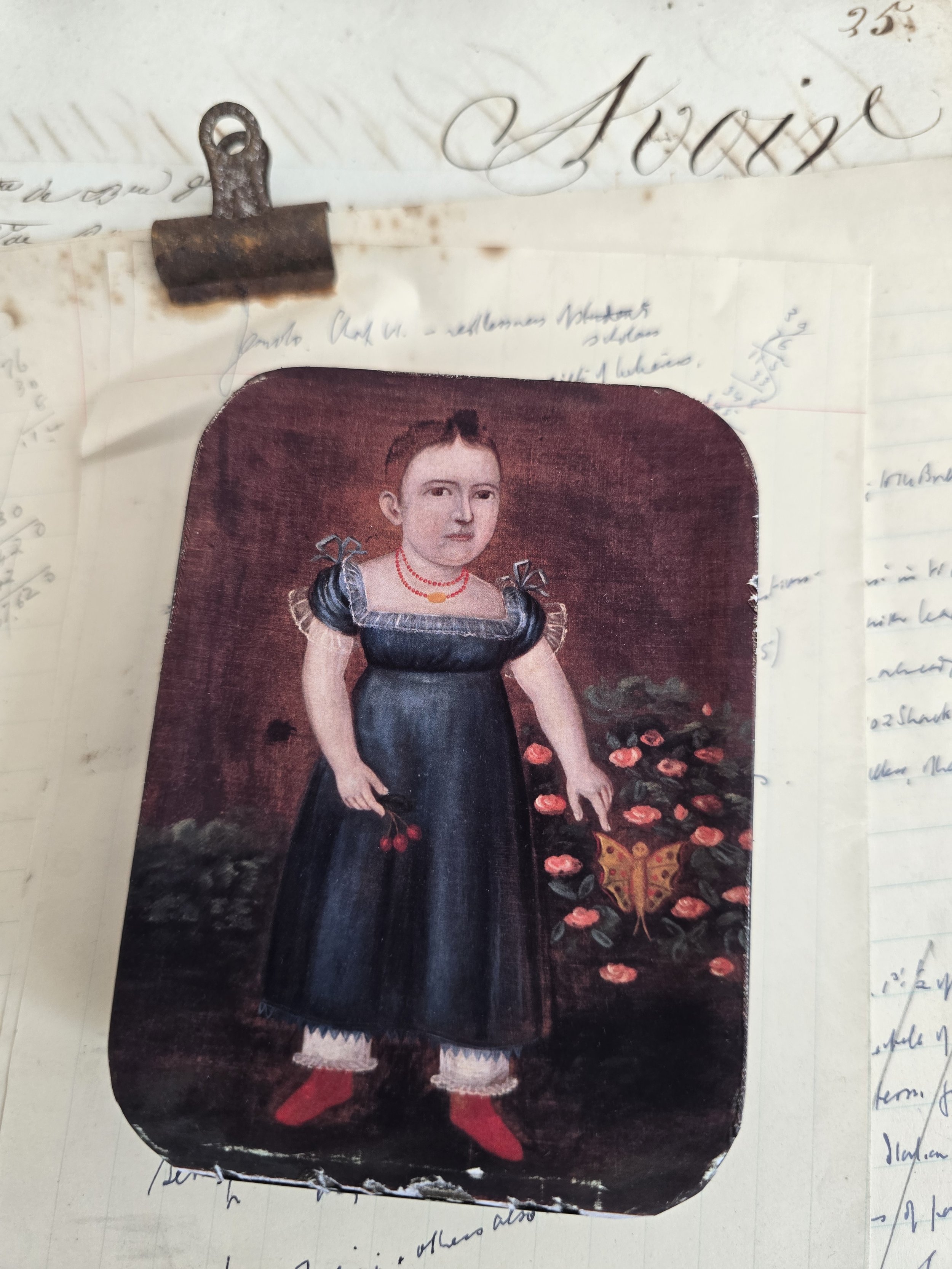 Studio made keepsake tin featuring a folk art portrait of a child holding cherries beside flowers and a butterfly.