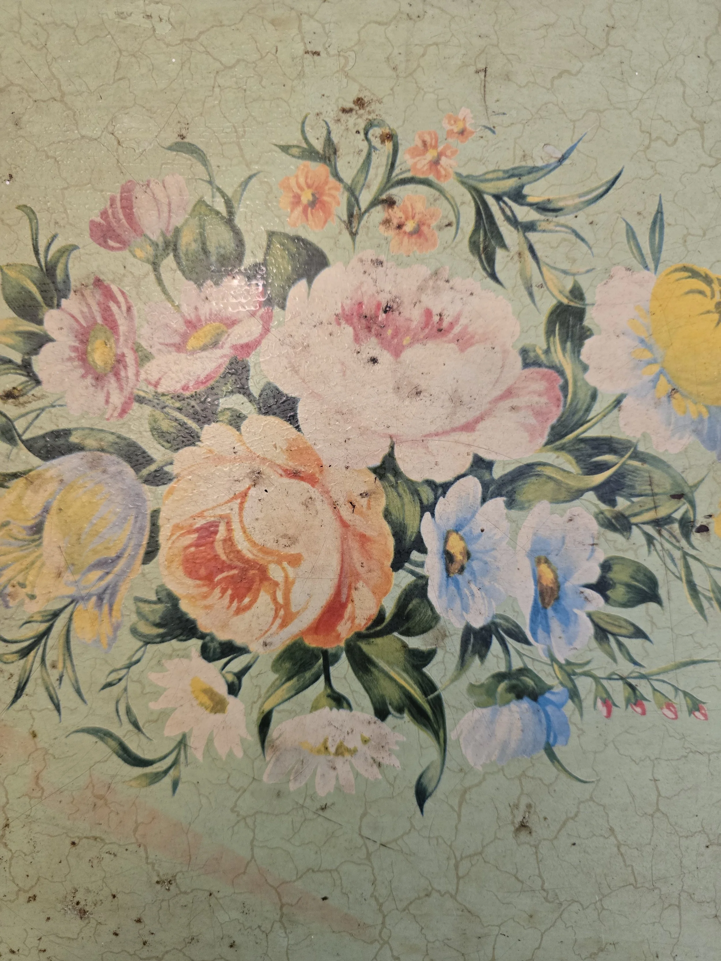 Detail of romantic pastel floral bouquet on worn mid-century metal serving tray with age marks. (Copy)