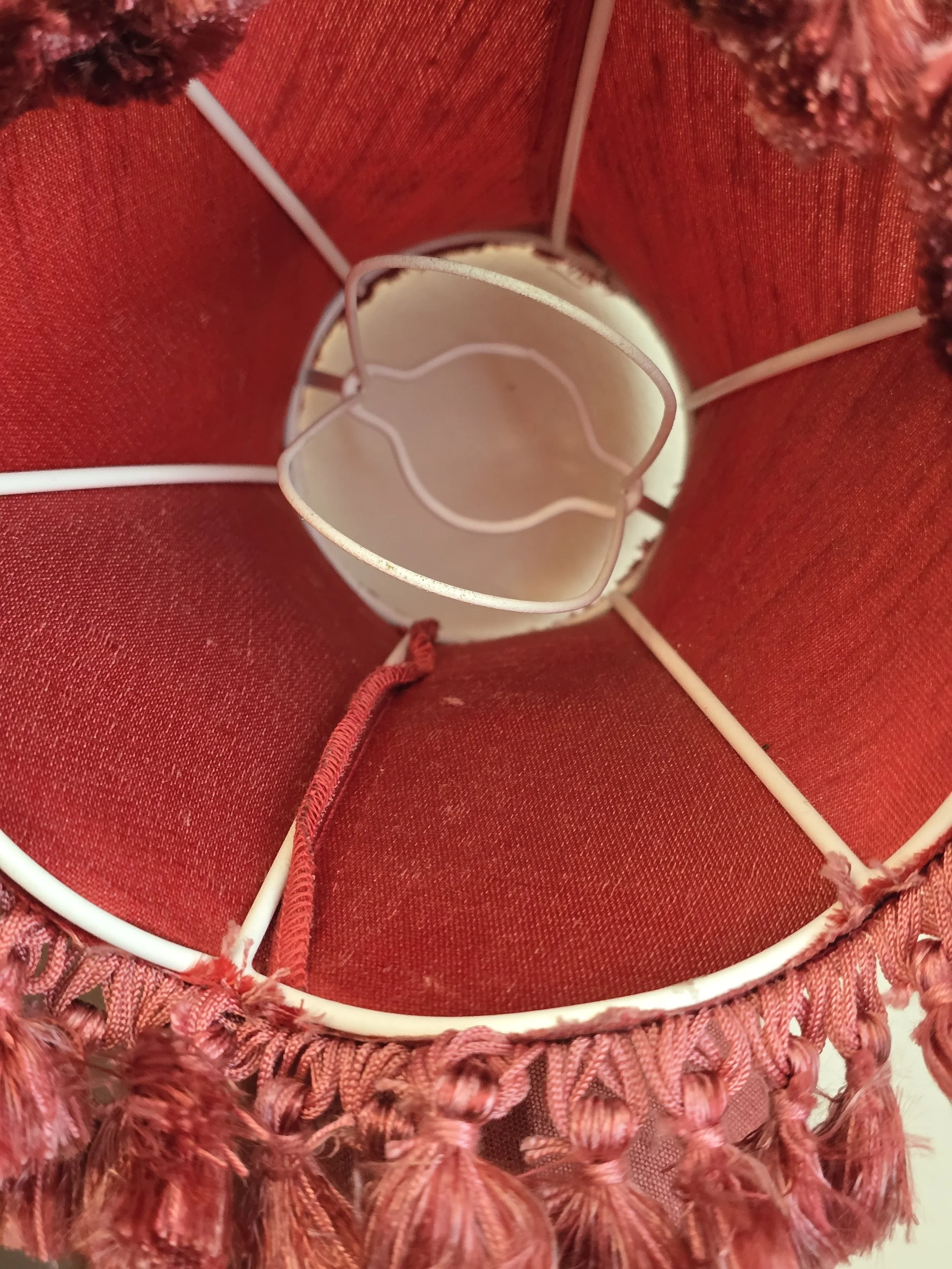 Detailed view of layered fringe and tassel trim on vintage shade.