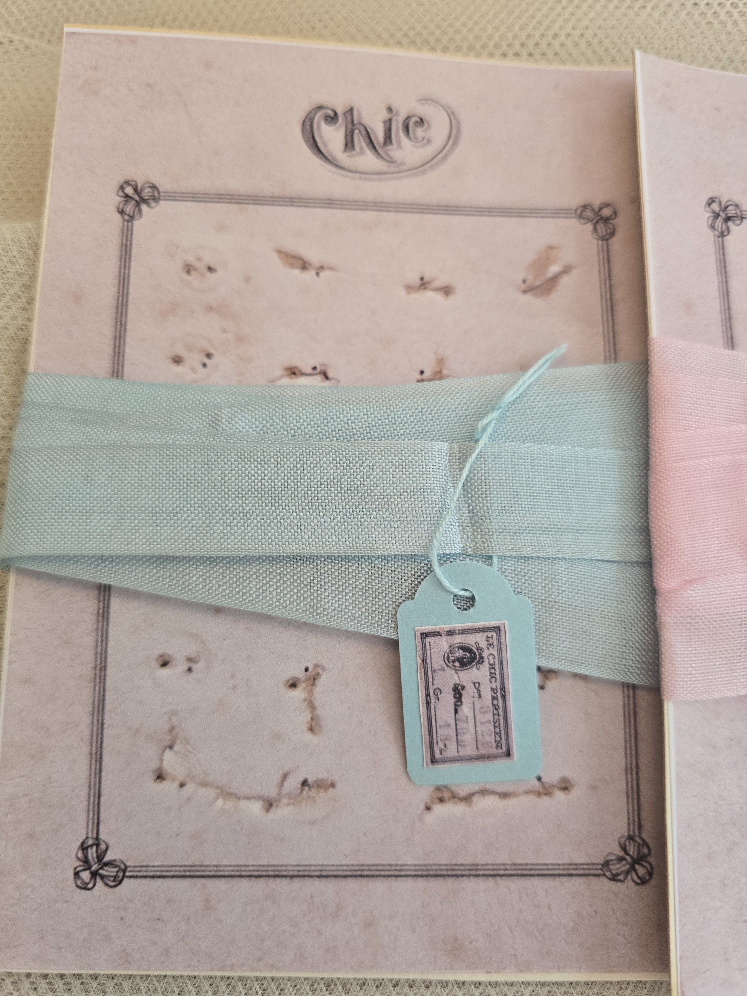 Two studio-made vintage style haberdashery cards wrapped with original French pink and blue ribbon.