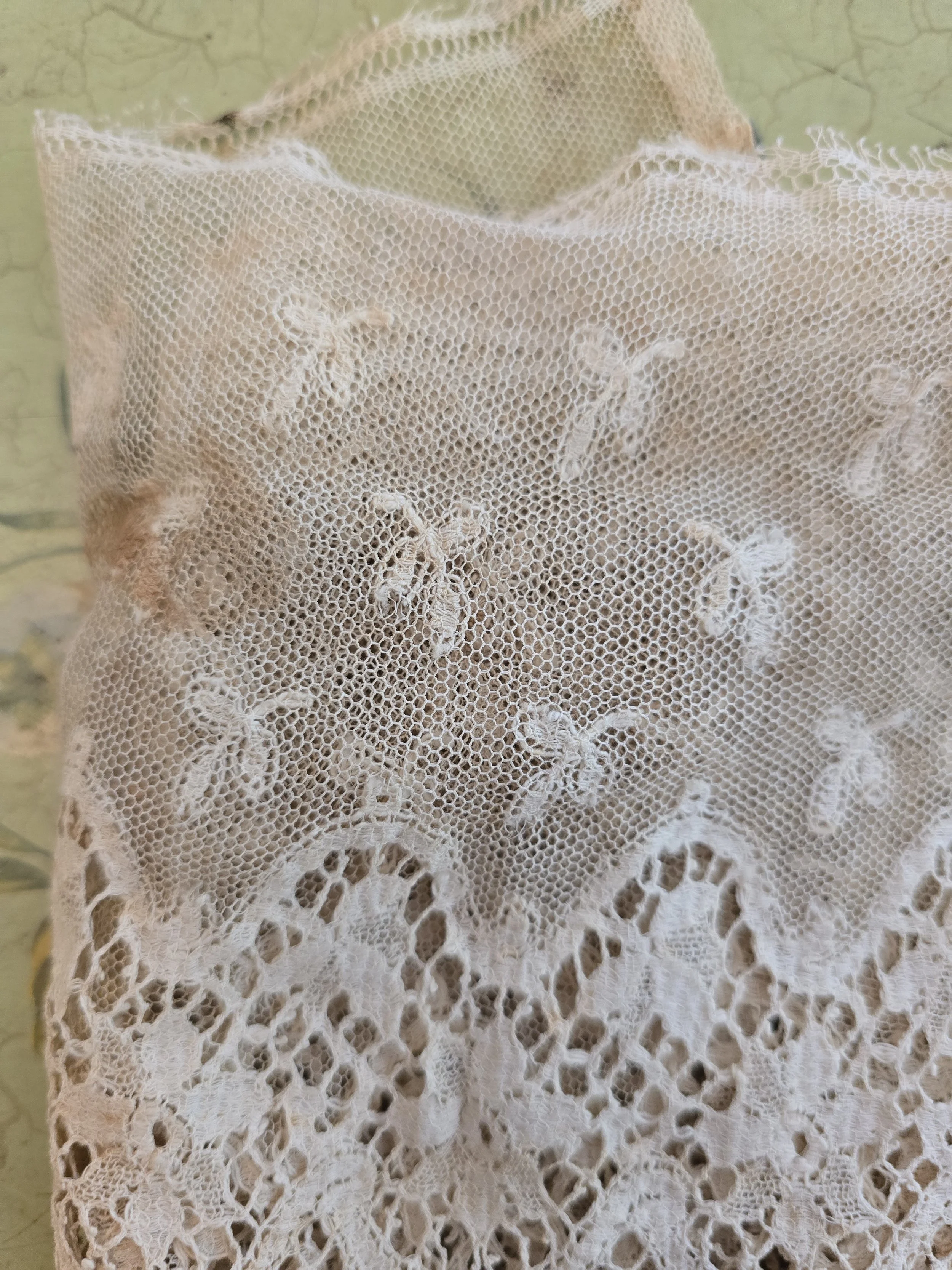 Close up of delicate Edwardian net lace with embroidered motifs