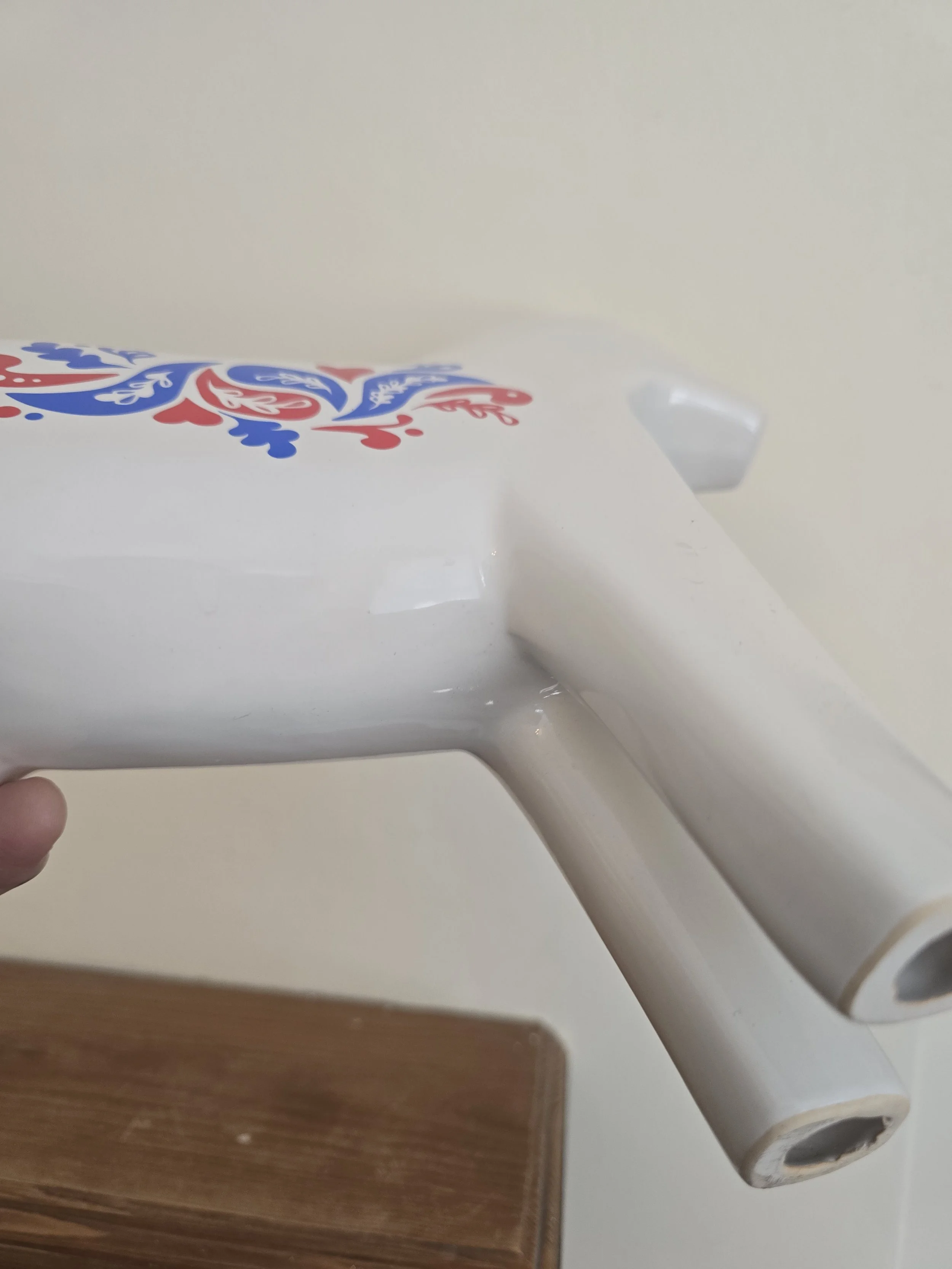 Side profile of vintage Swedish style ceramic Dala horse figure