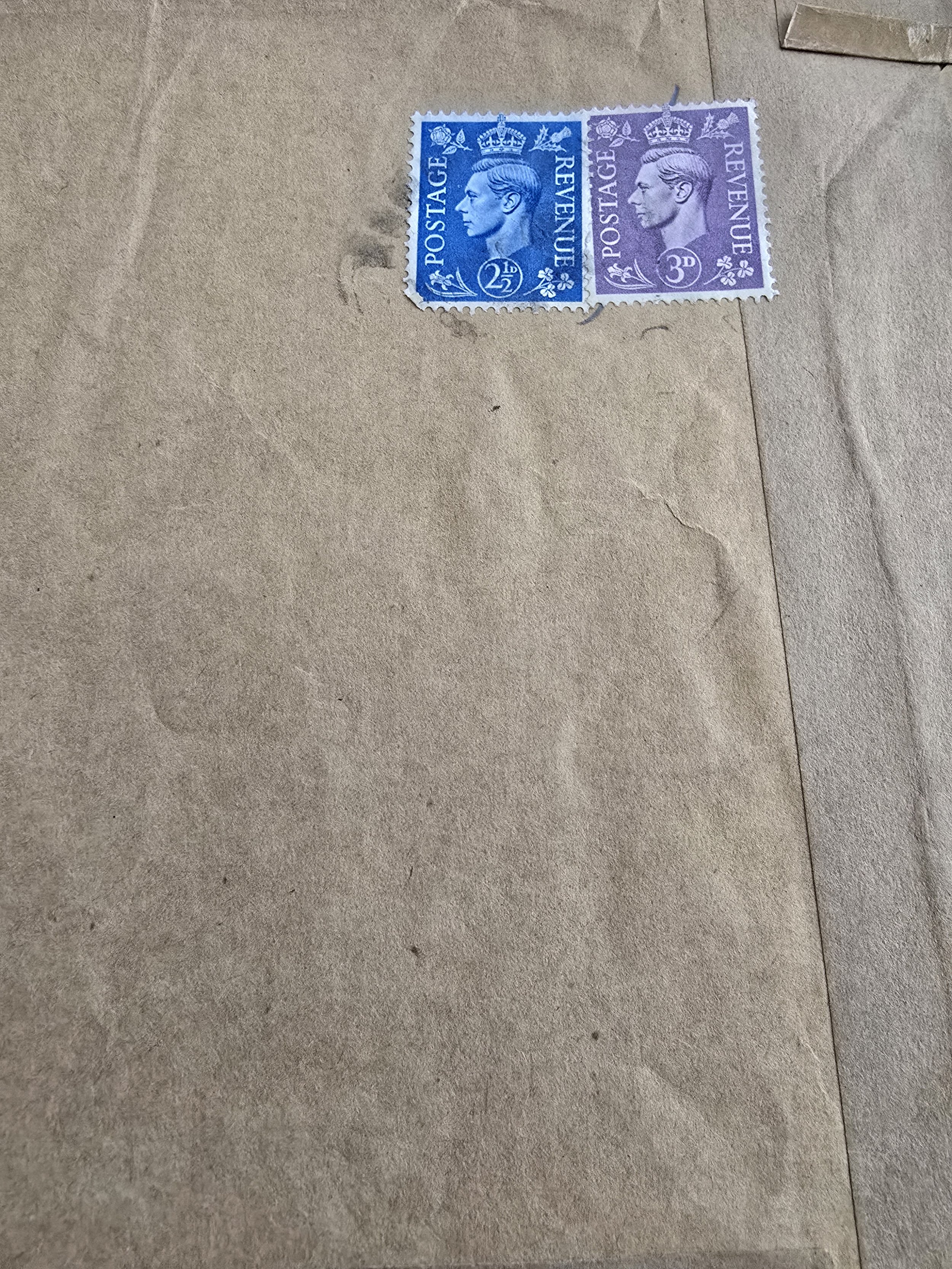 Vintage King George VI postage stamps on brown envelope