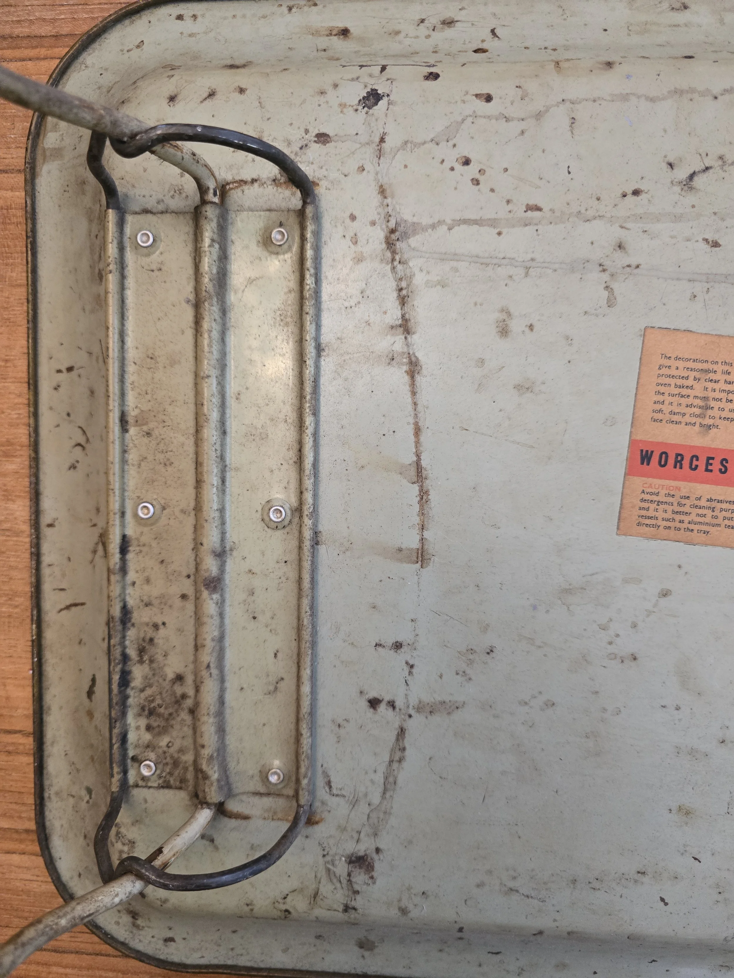 Underside of vintage folding bed tray showing metal legs and original Worcester Ware label. (Copy)