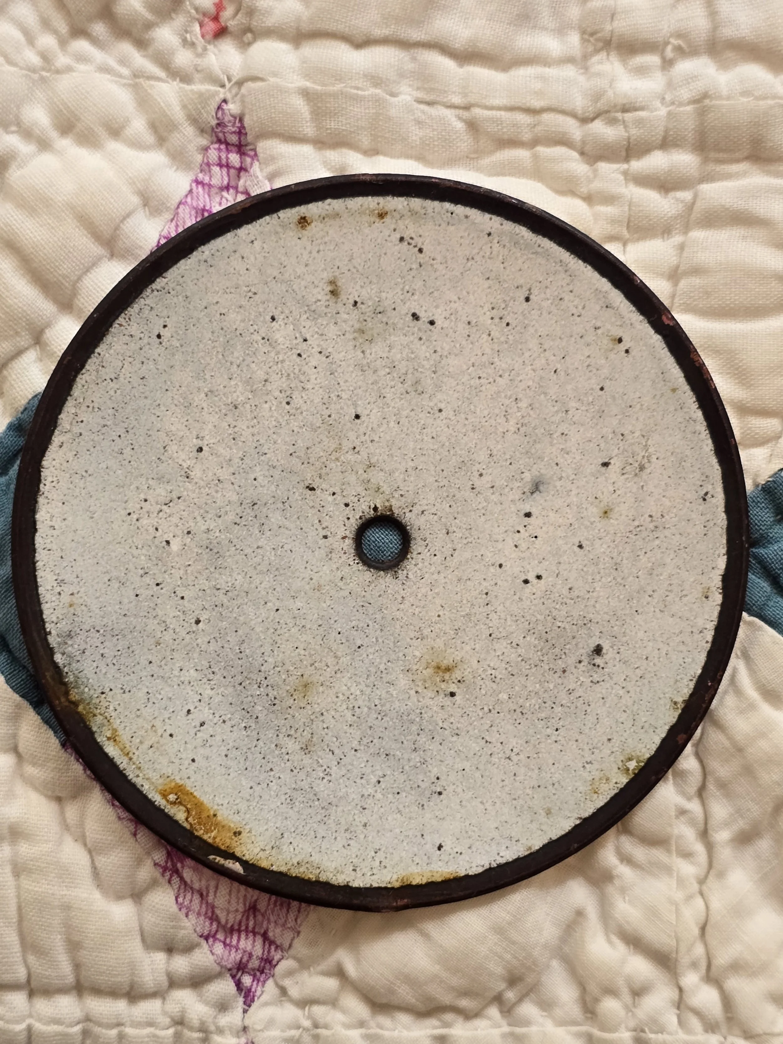 Reverse of antique French clock dial showing original metal backing and aged surface.