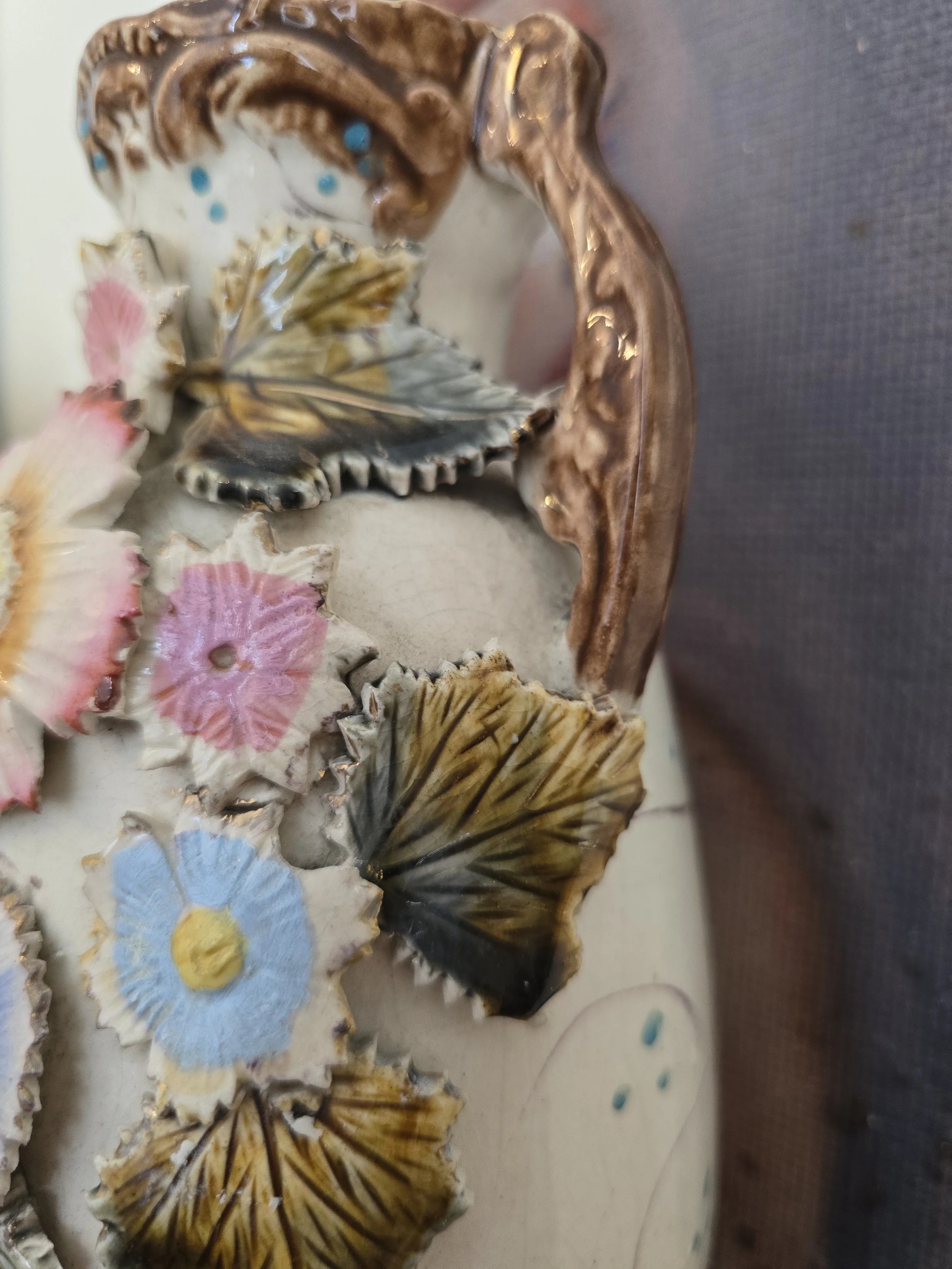 Detail of ornate handle and relief leaf decoration