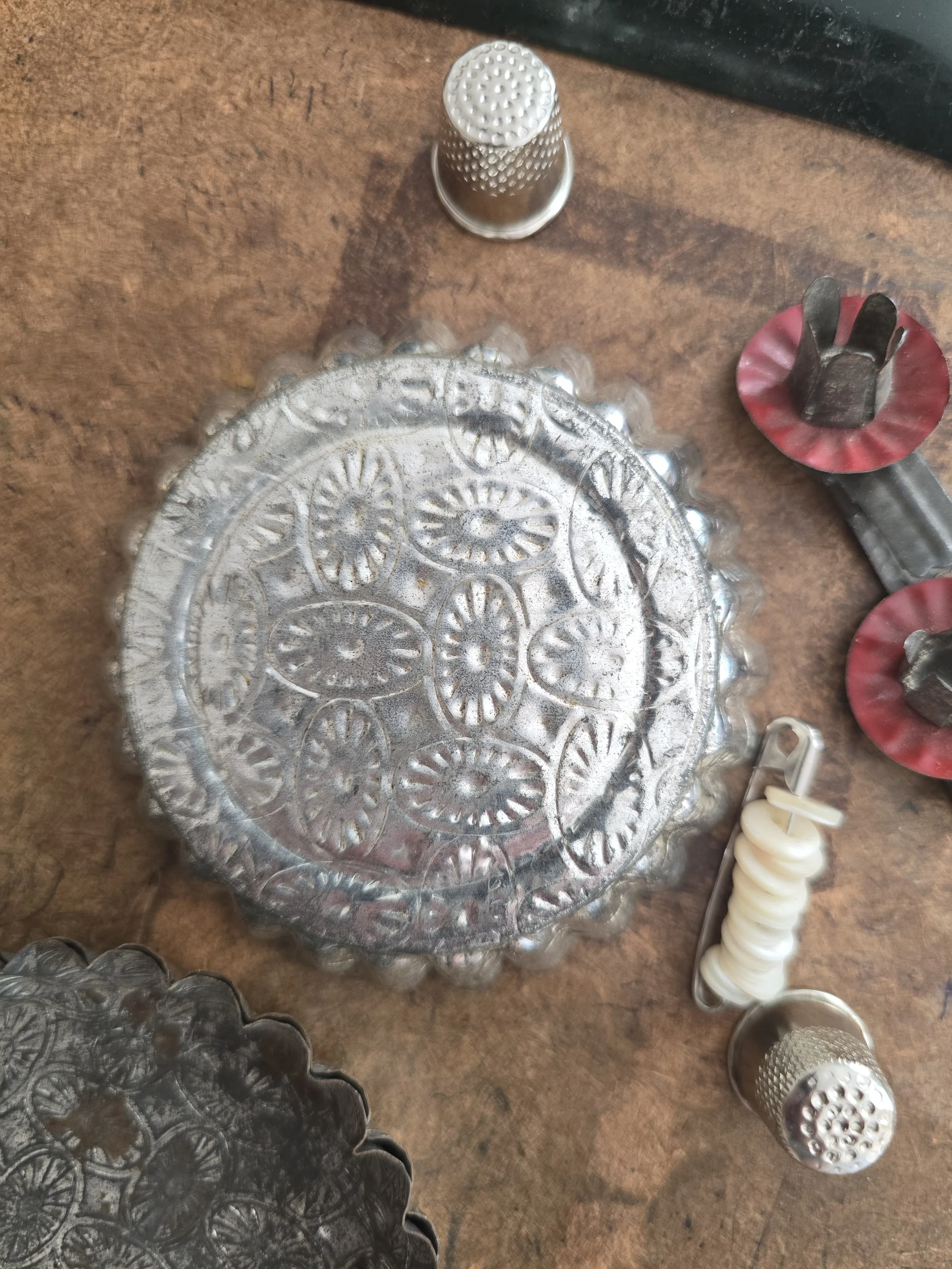 Reverse of vintage French metal pastry mould showing aged embossed surface
