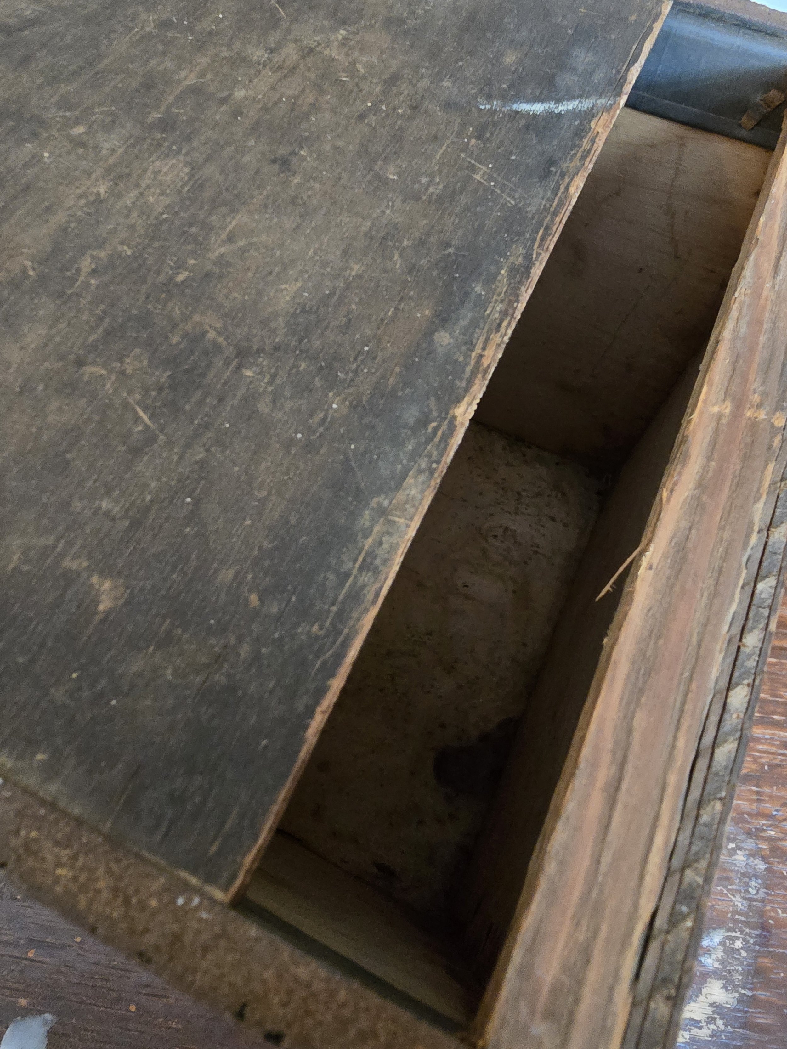 Sliding lid of antique wooden tea box with darkened patina