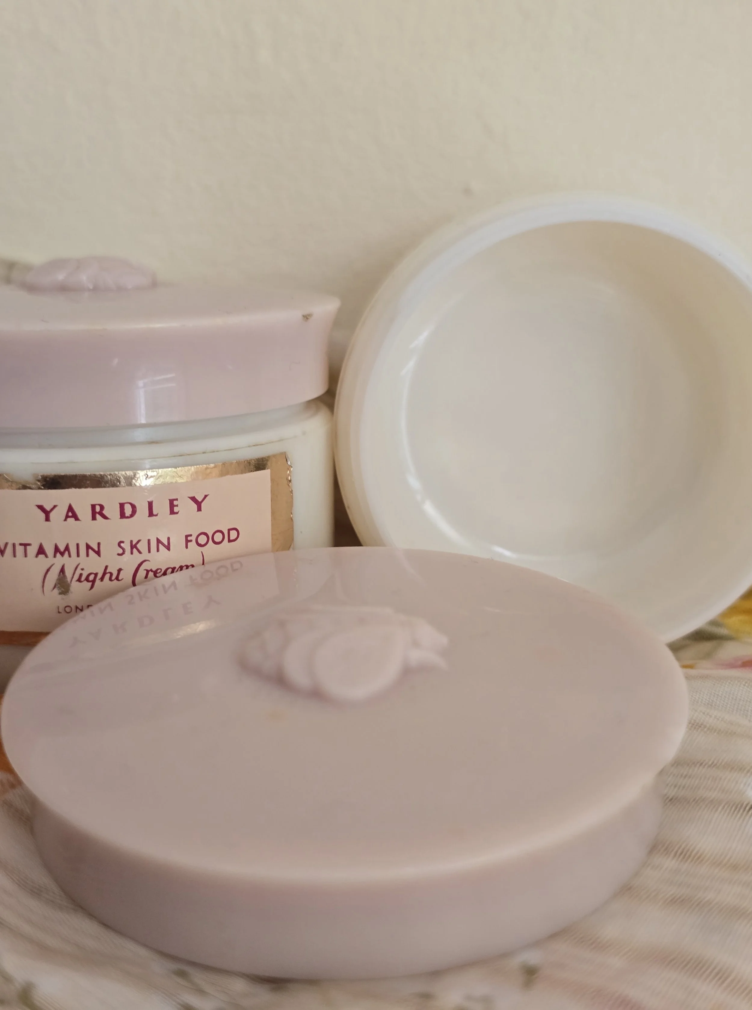 Angled photo of vintage Yardley jar showing soft pink lid and aged gold label