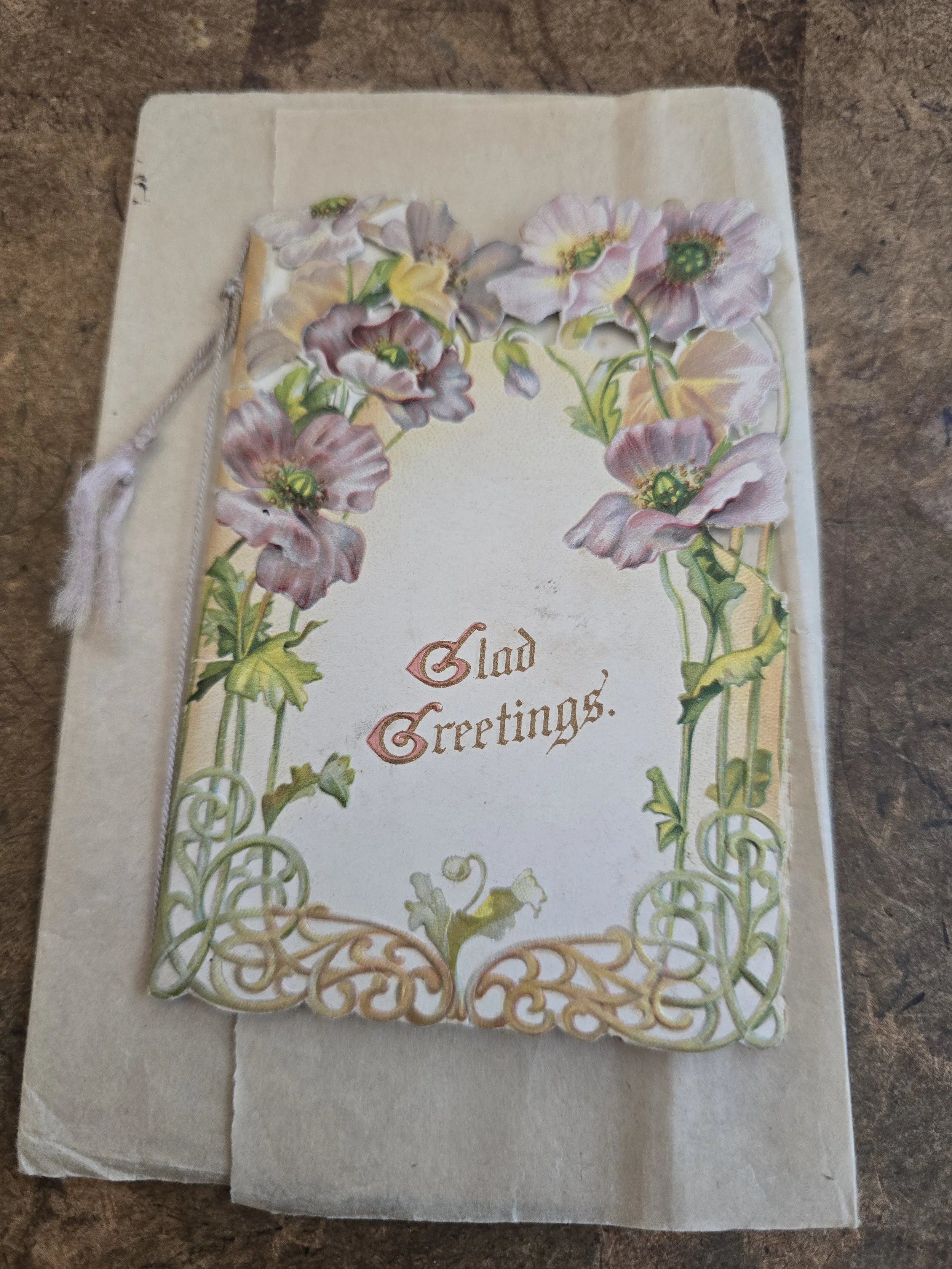 Antique Raphael Tuck & Sons floral Christmas greeting card with original envelope and tassel tie