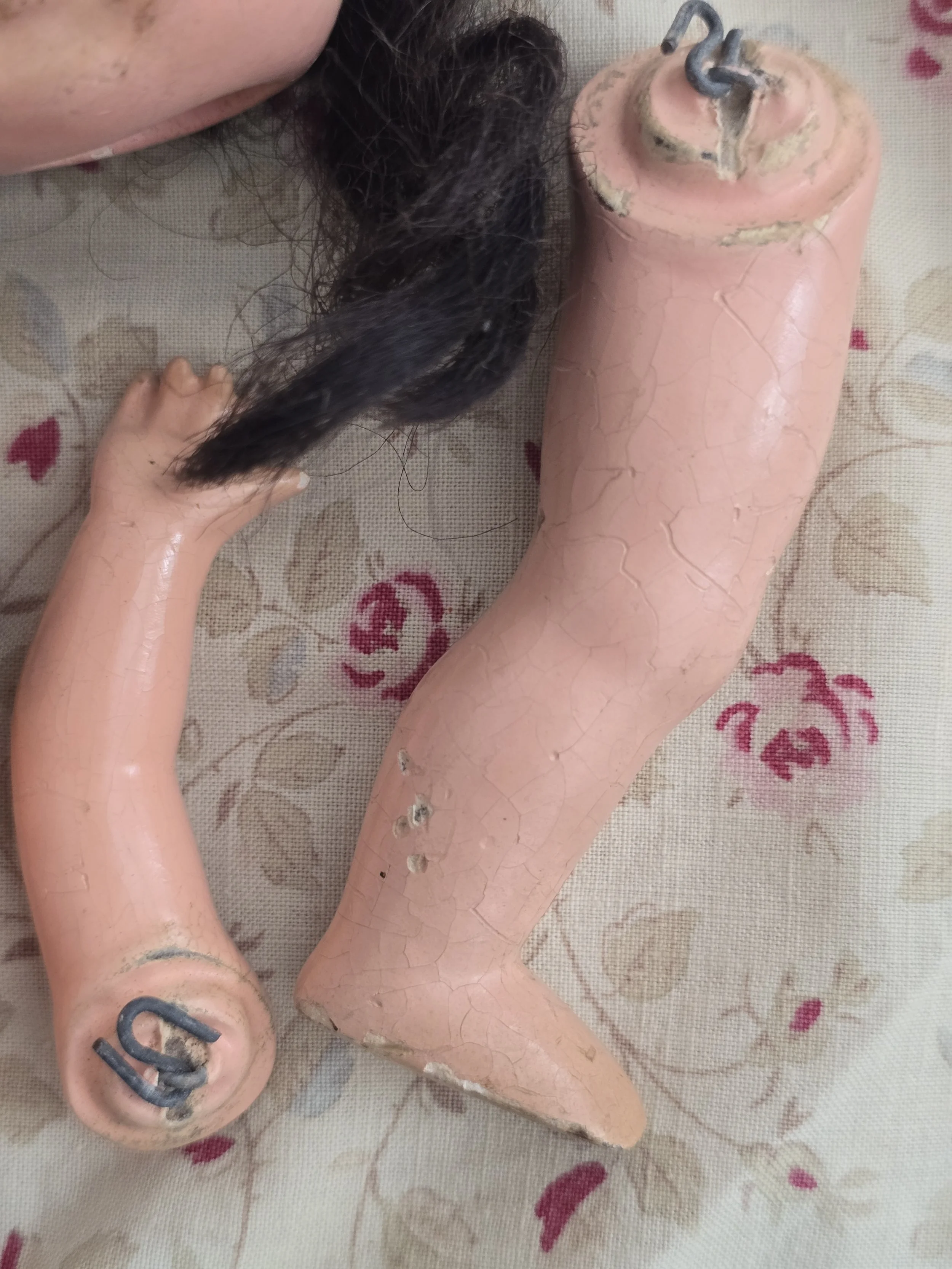 Detached doll limbs from an early vintage doll.