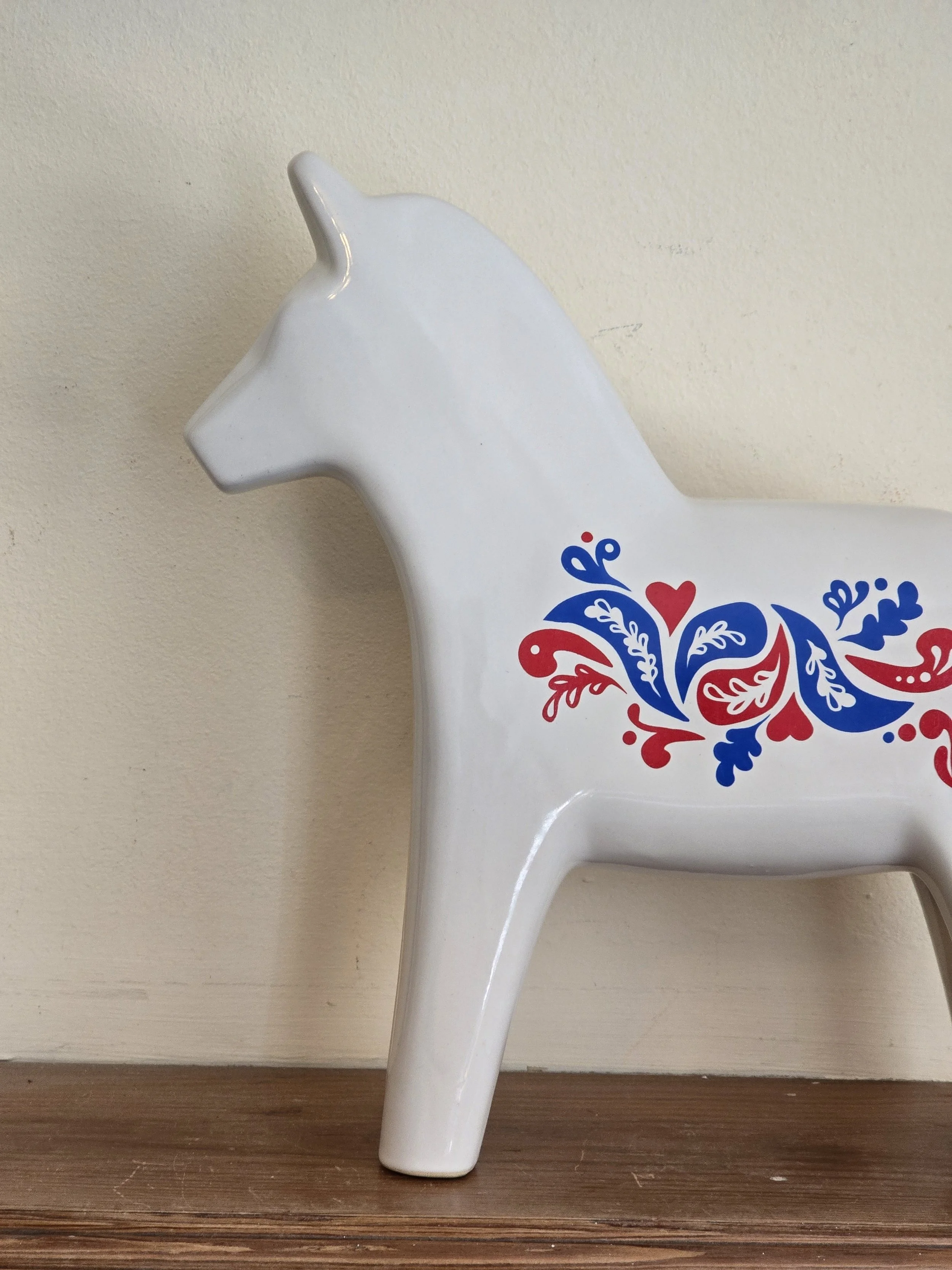 Close-up of red and blue folk art decoration on vintage IKEA Dala horse