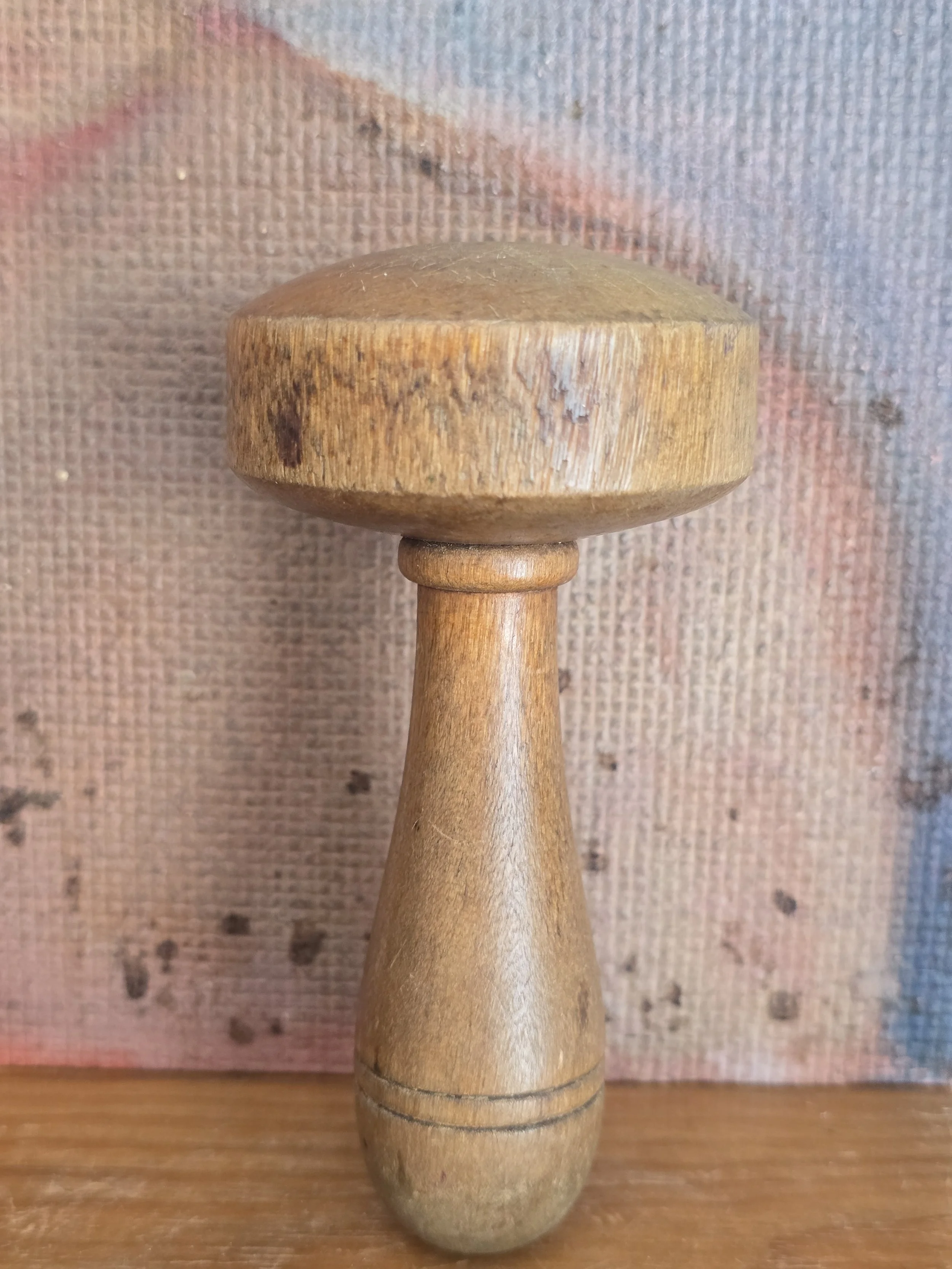 Vintage wooden darning mushroom displayed as a textile collector's object.
