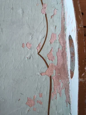 Edge detail of French vintage tray with flaking blue paint and gilt border