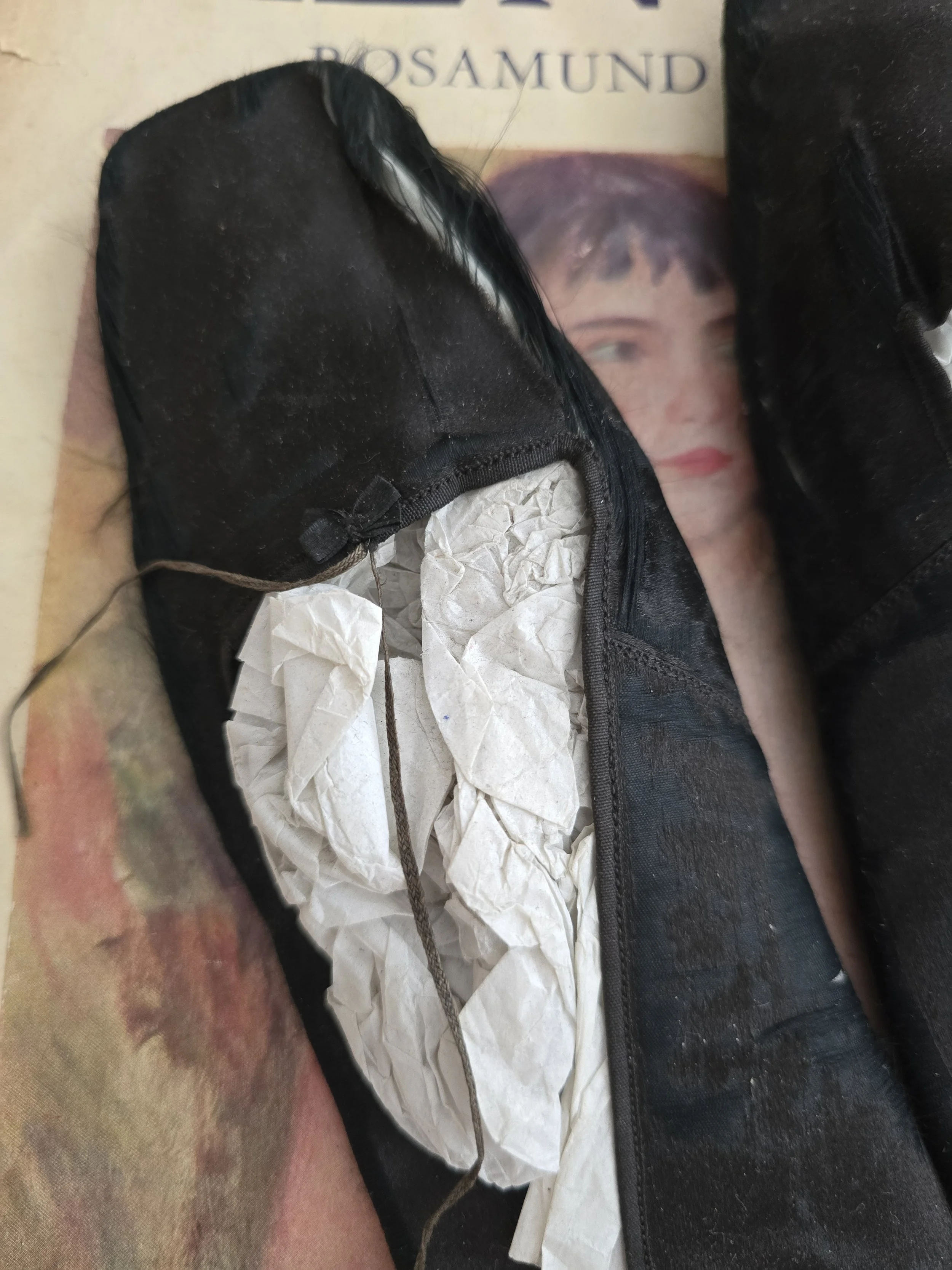 Late Victorian silk slippers showing square toes and satin finish.