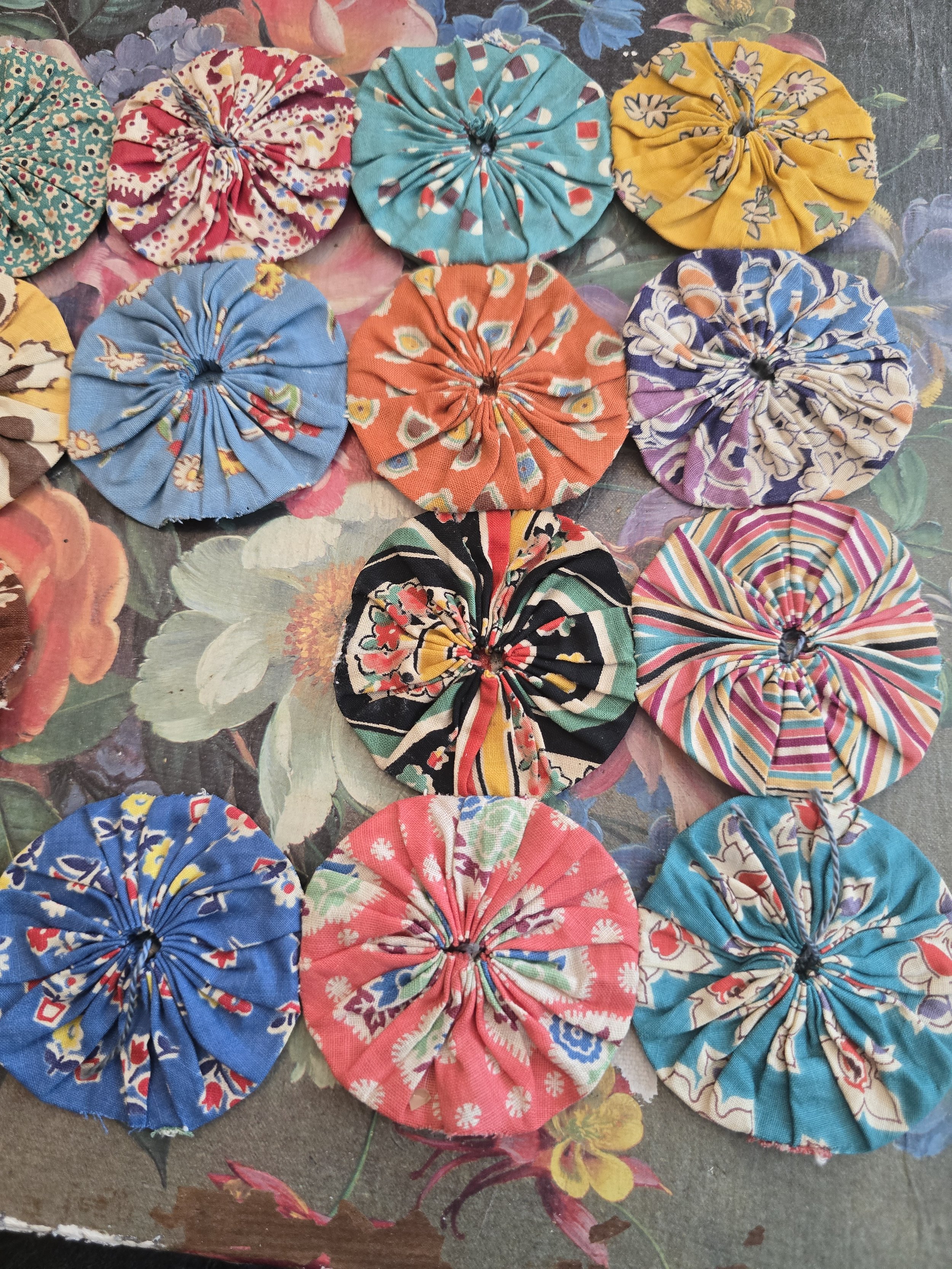 Handmade vintage quilt pieces arranged together showing a variety of fabric patterns.