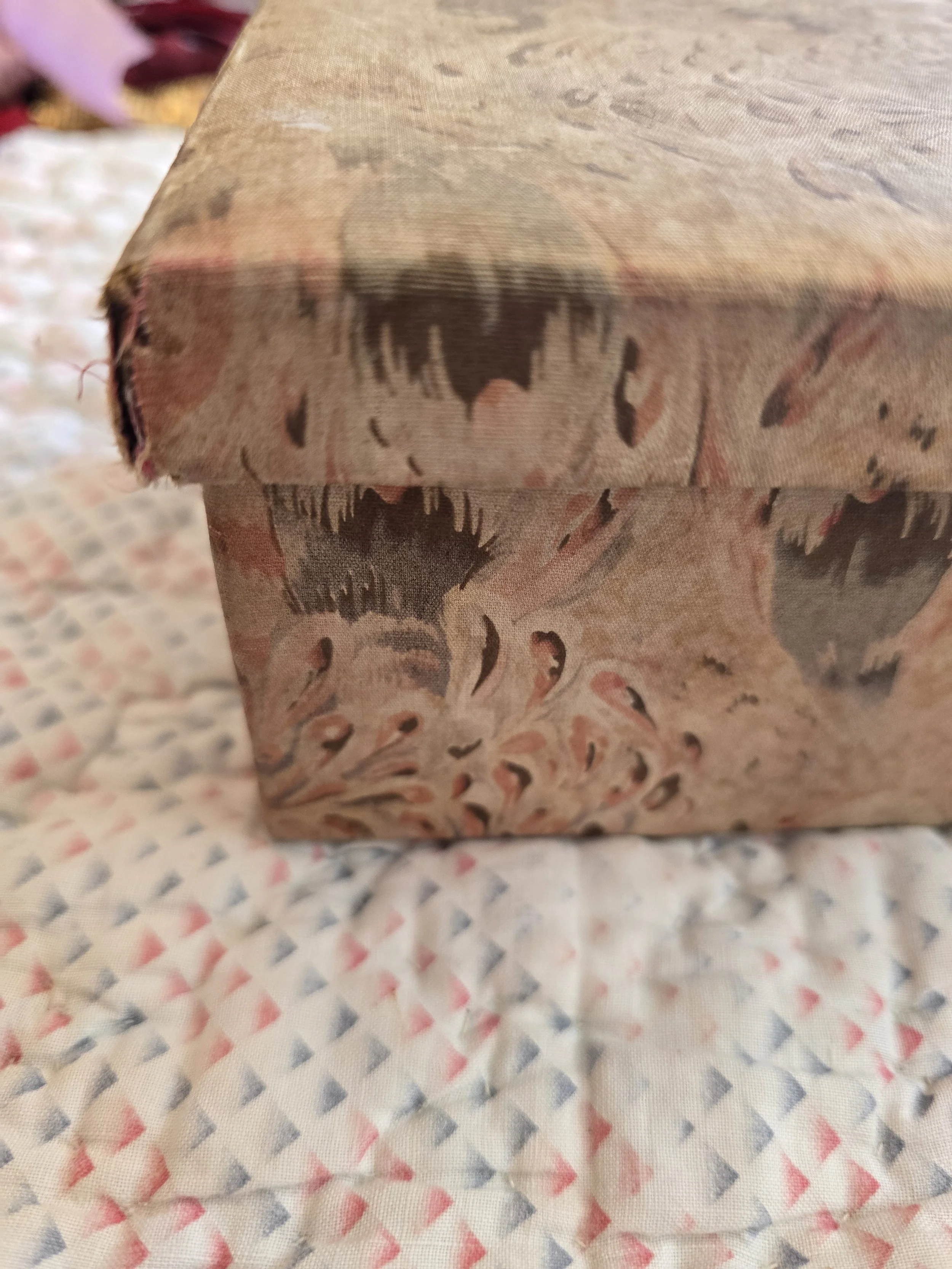 Interior view of vintage fabric-covered box showing original aged lining.