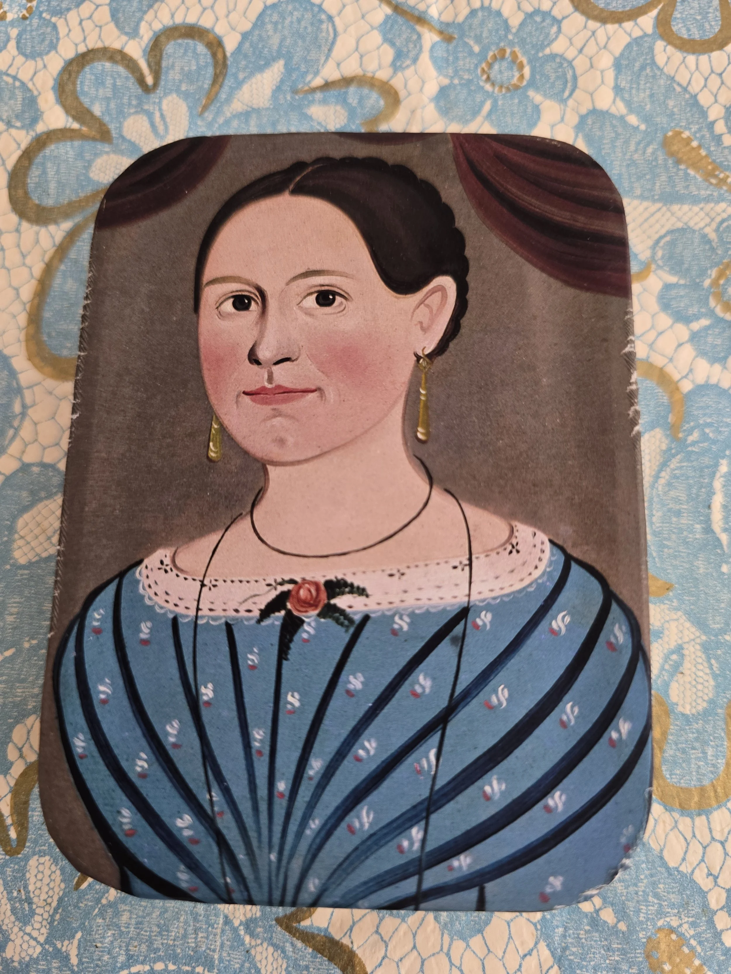 Studio made vintage tin featuring a nineteenth-century style female portrait.