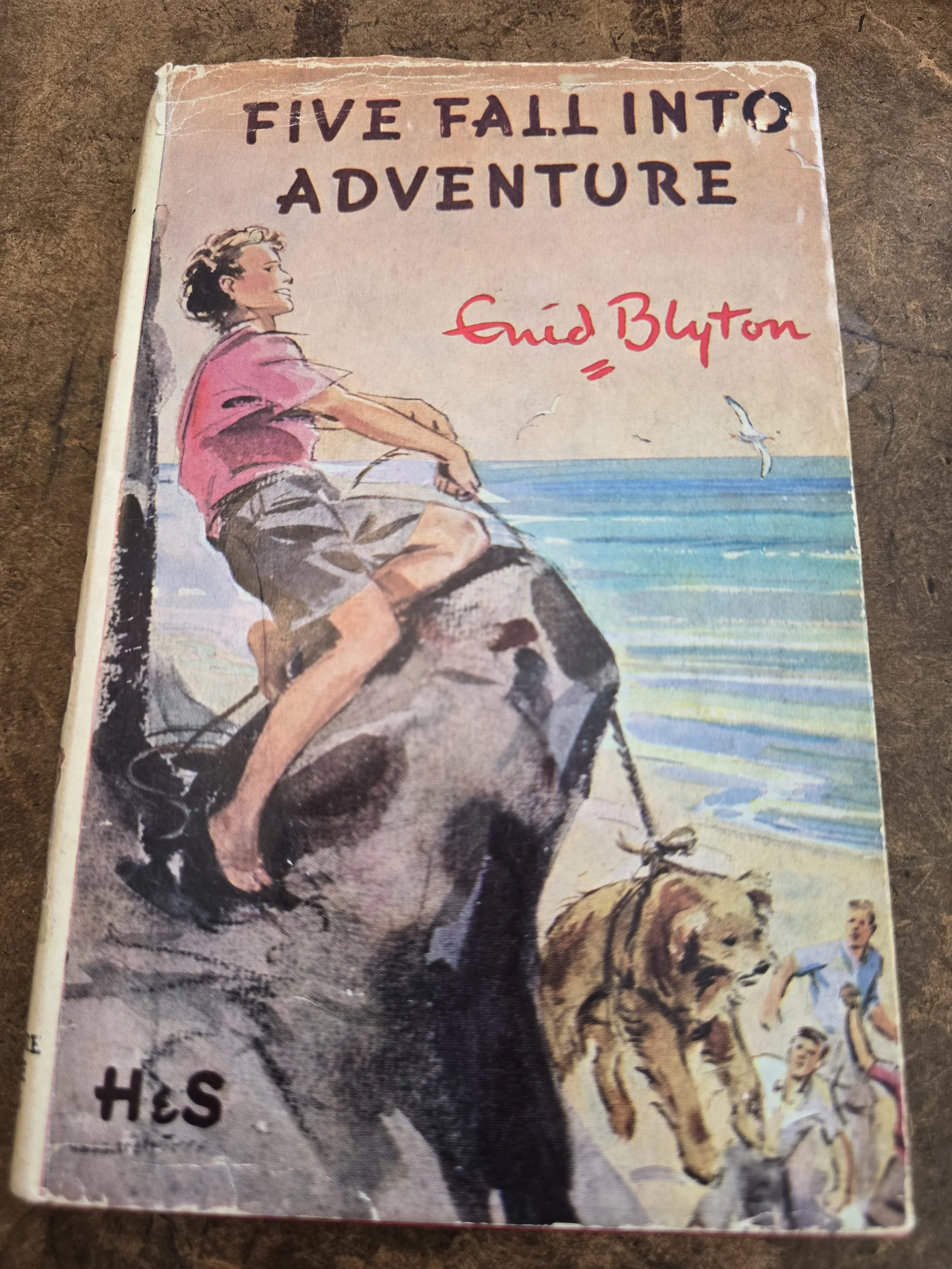 Front cover of vintage Enid Blyton Five Fall Into Adventure hardback with original illustrated dust jacket.