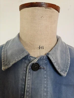 Collar detail with small stitched repair at back neck