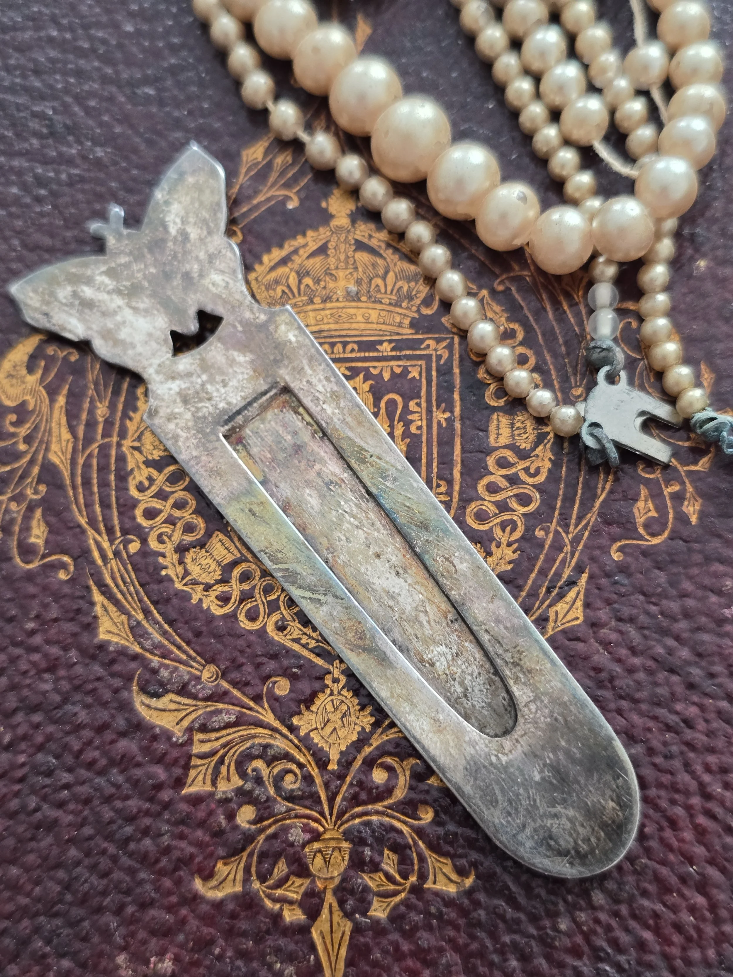 Reverse of vintage butterfly page marker showing sprung clip mechanism.