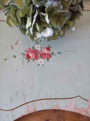 Detail of folding wooden legs on French vintage tray with pale paint