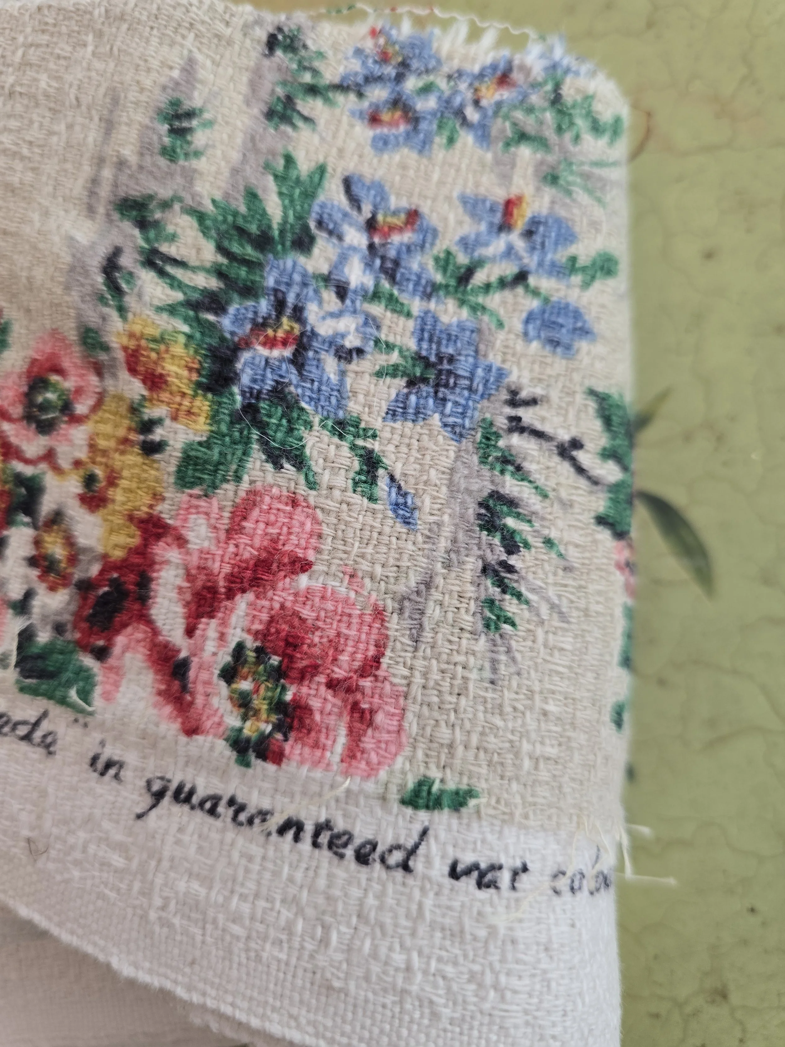Timeworn floral fabric fragment with textured woven surface
