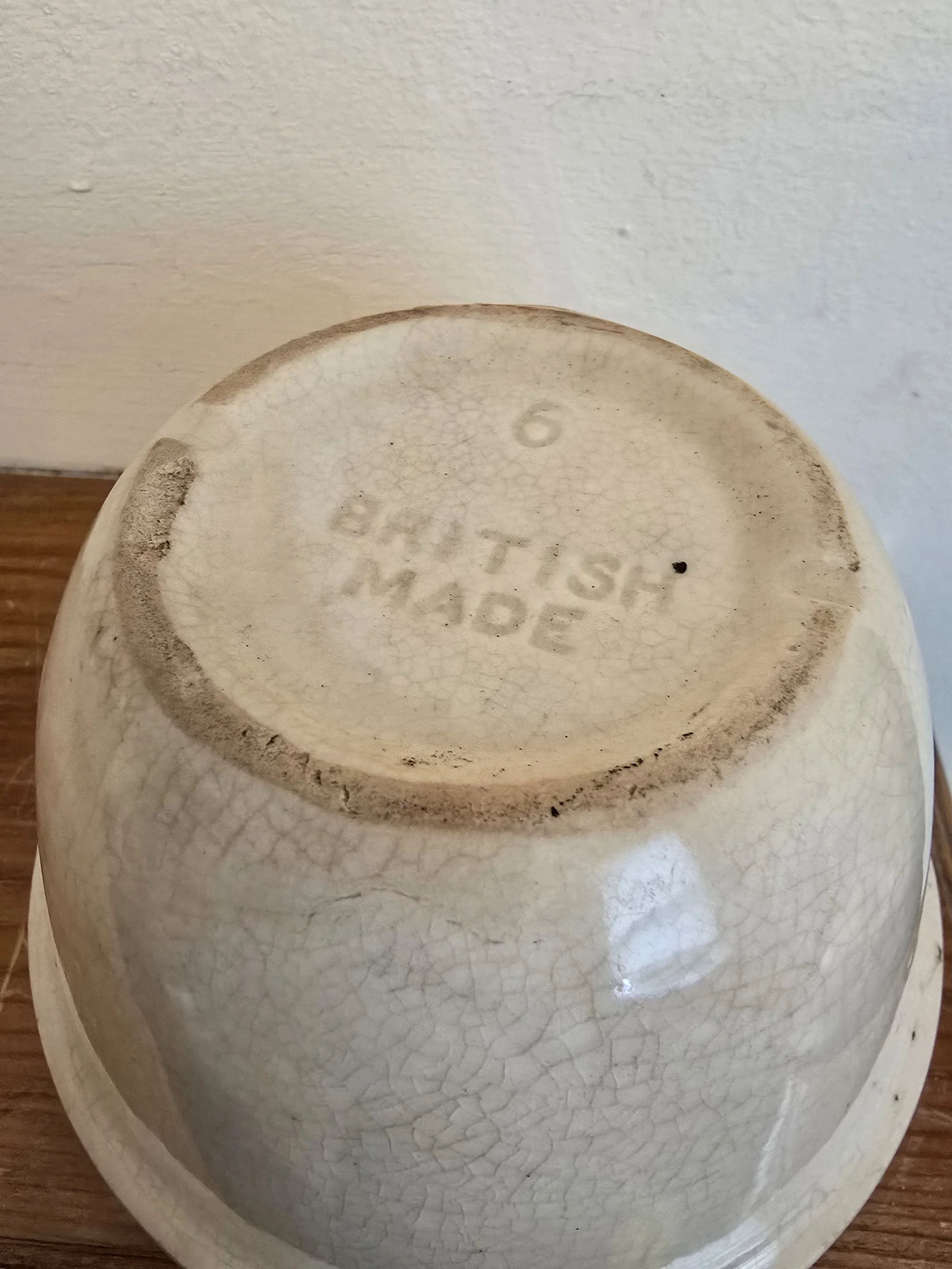 Base of small vintage British pudding bowl with crazed ivory glaze