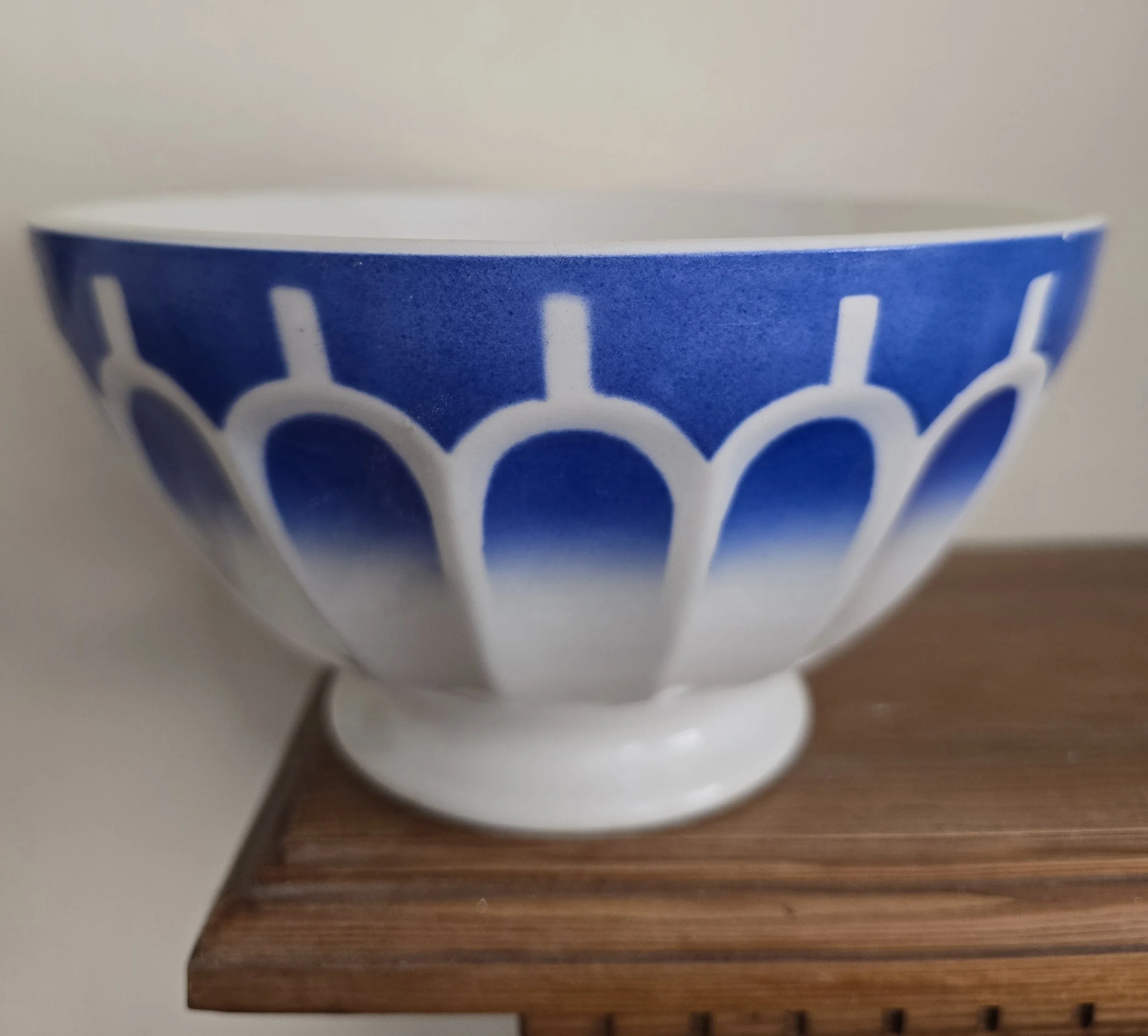Close-up of large French café au lait bowl with blue airbrushed arches