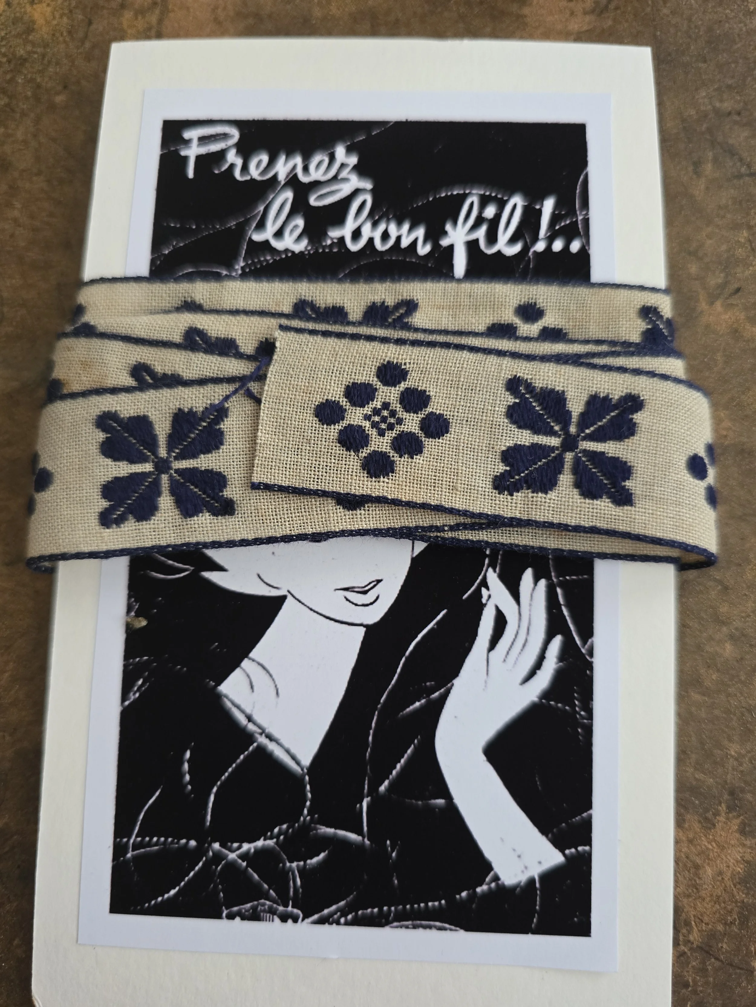 One metre of vintage cream and navy woven trim presented on a handmade French image display card.
