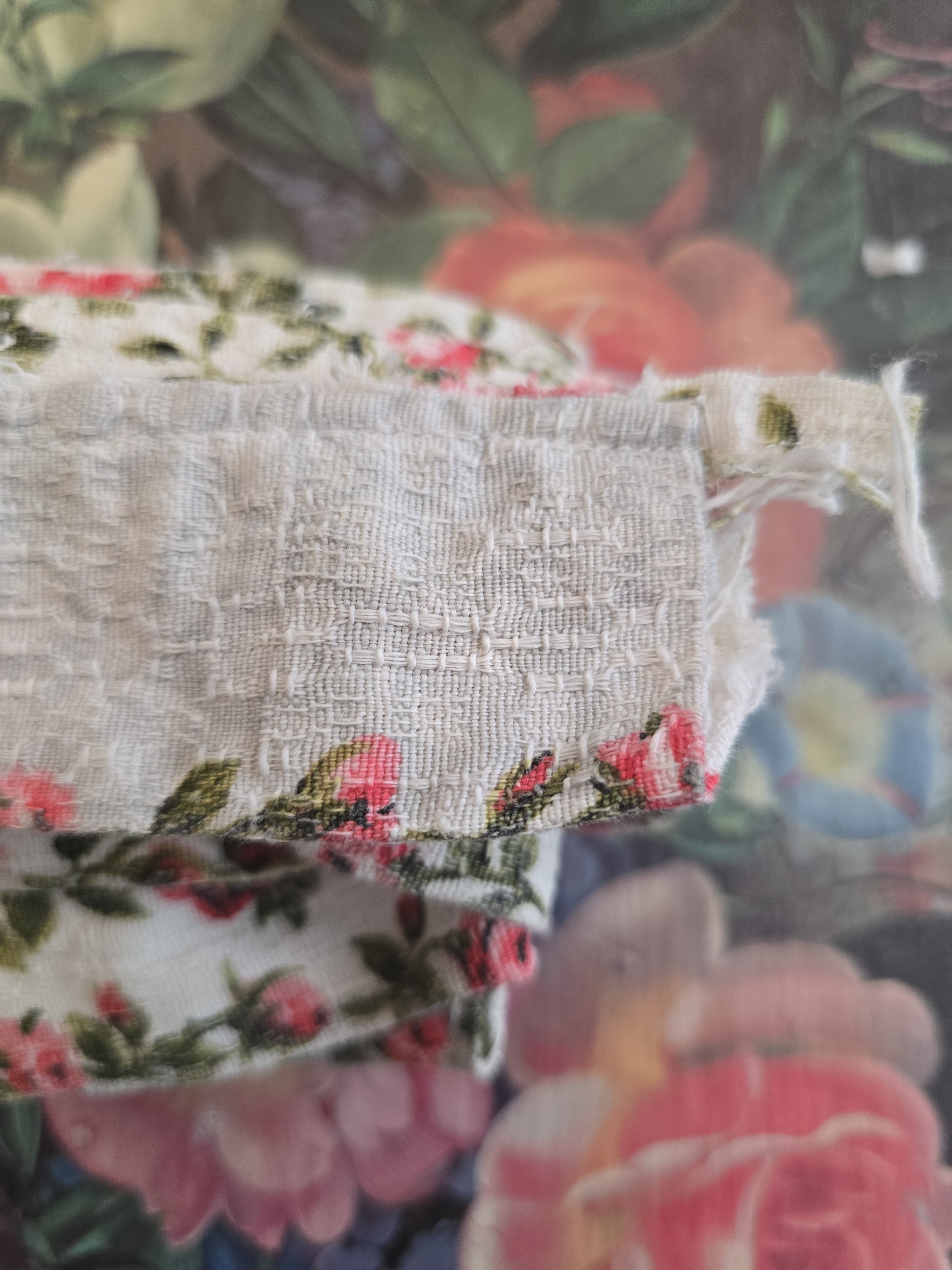 Cottage-style barkcloth trim featuring pink roses and green foliage.