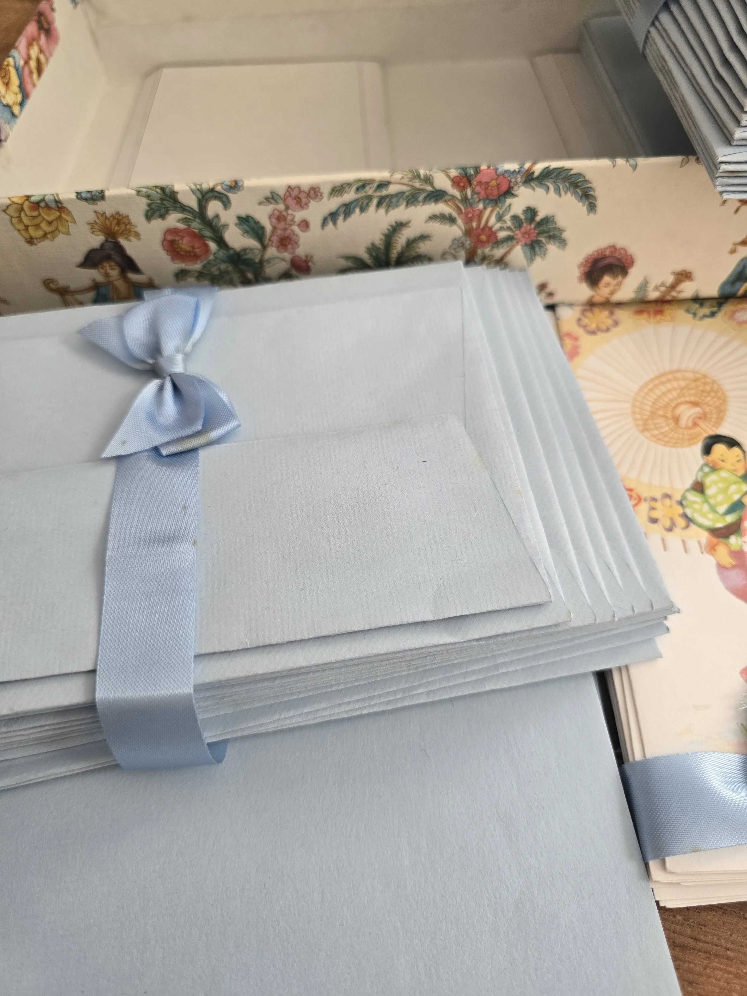 Bundles of vintage pale blue envelopes tied with matching blue ribbon