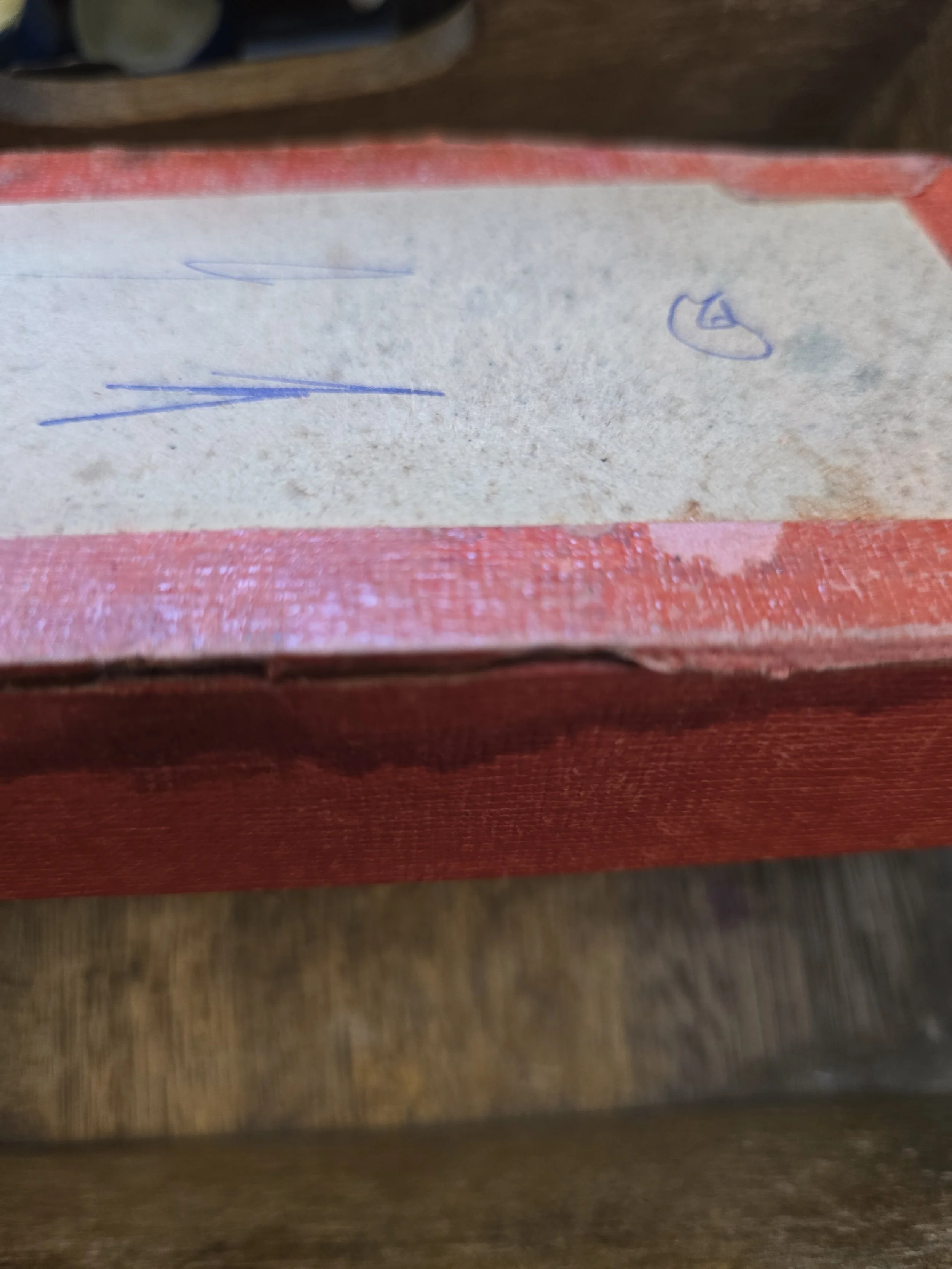 Original red draughts box showing age and wear