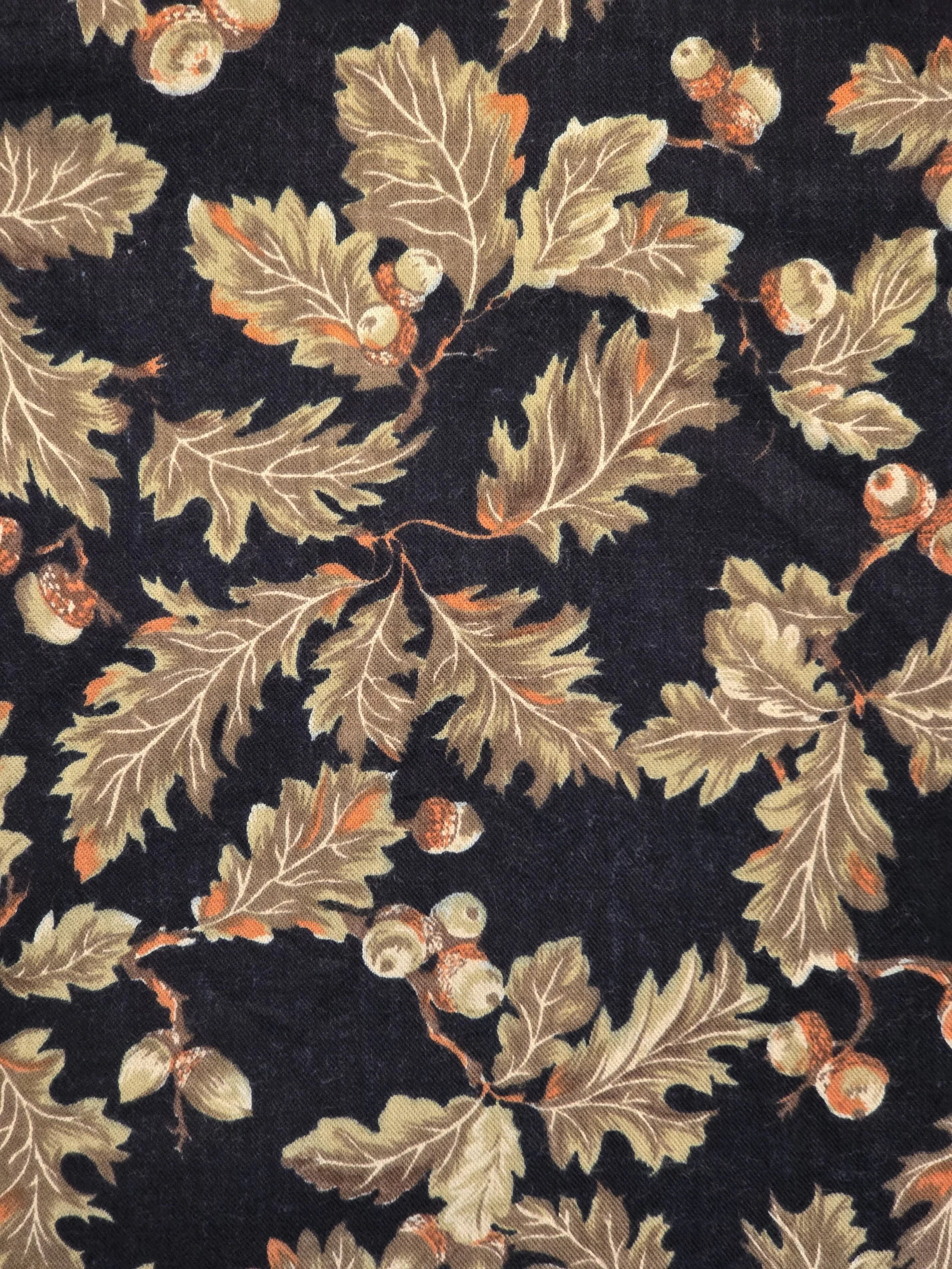 Dark background fabric decorated with oak leaves and acorns