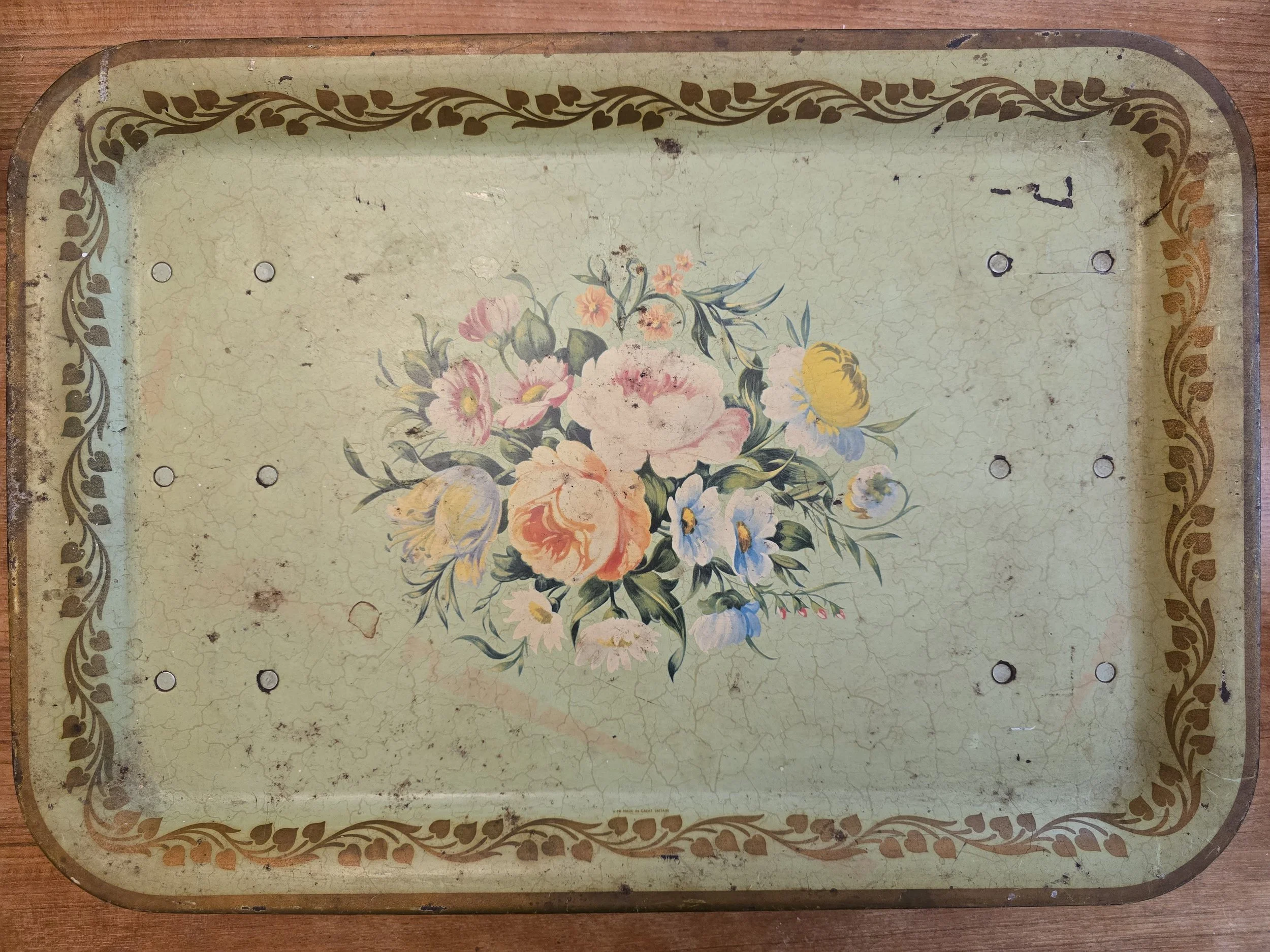 Vintage floral bed tray with folding legs and pastel bouquet design on pale green crackle background. (Copy)