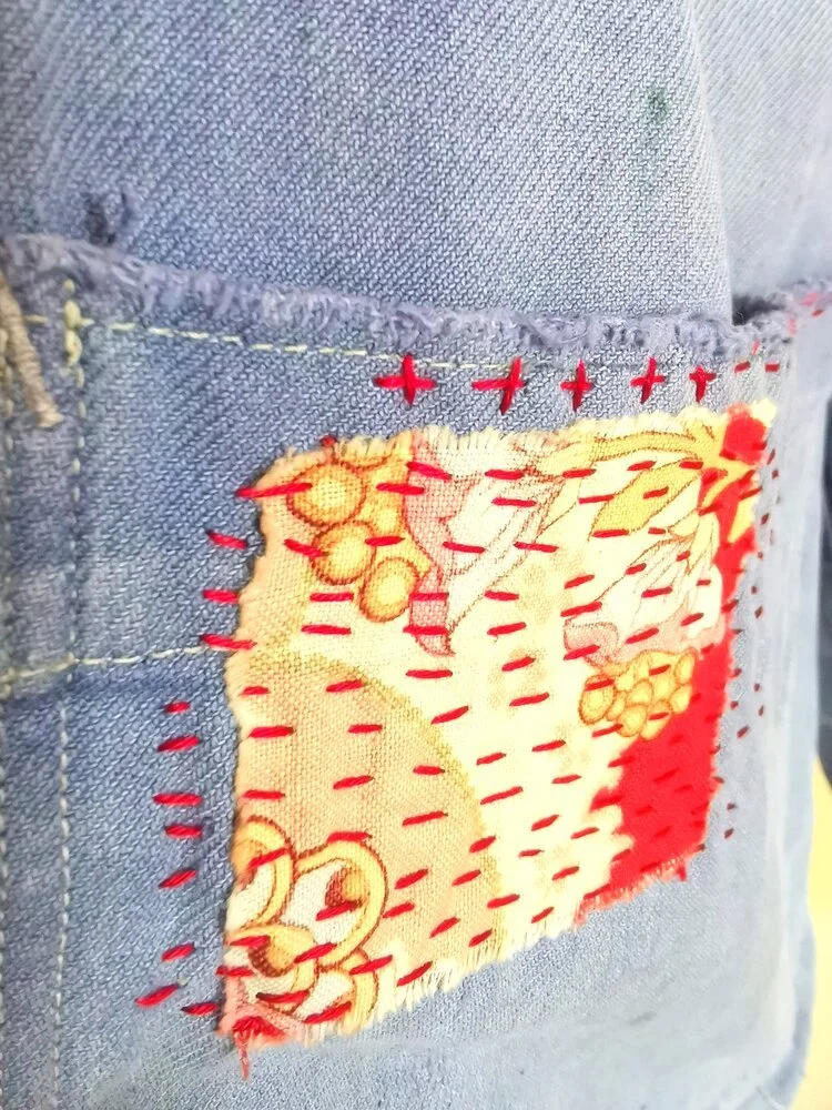 Close-up of sashiko stitching on antique red floral patch