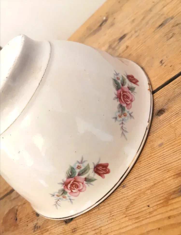Oversized French floral footed bowl styled on rustic wooden table