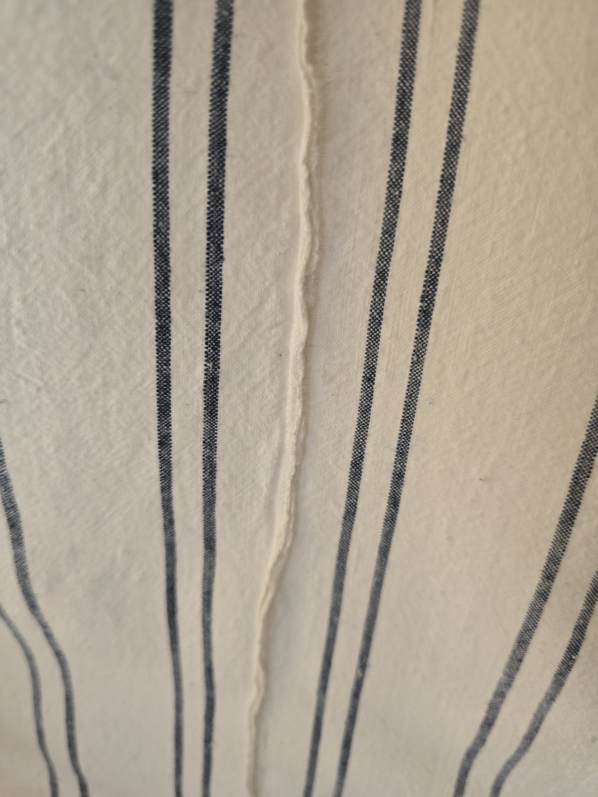 Antique homespun cotton sheet displaying the finely stitched pieced panel construction.